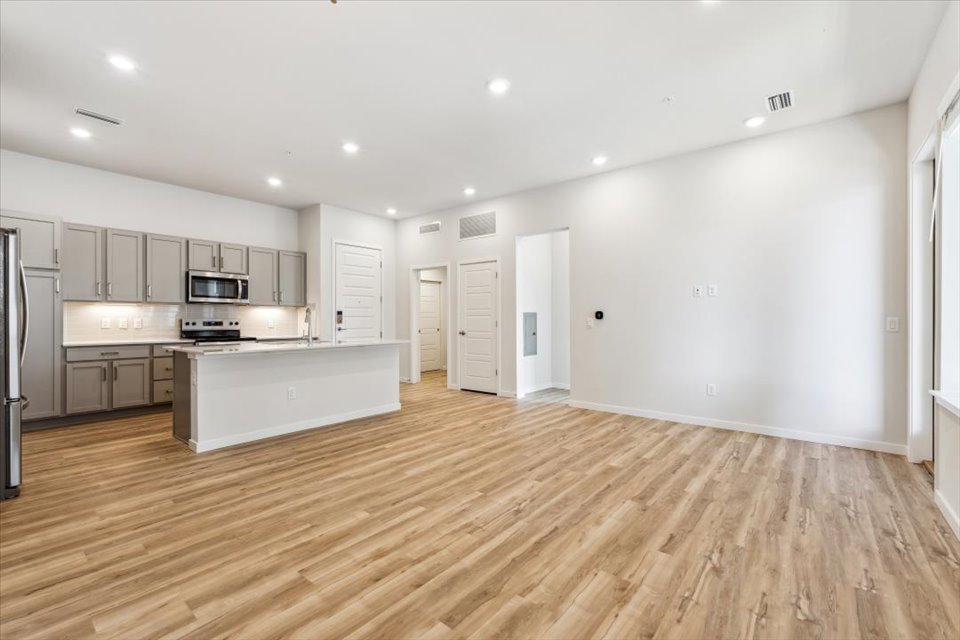 A kitchen with white cabinets.