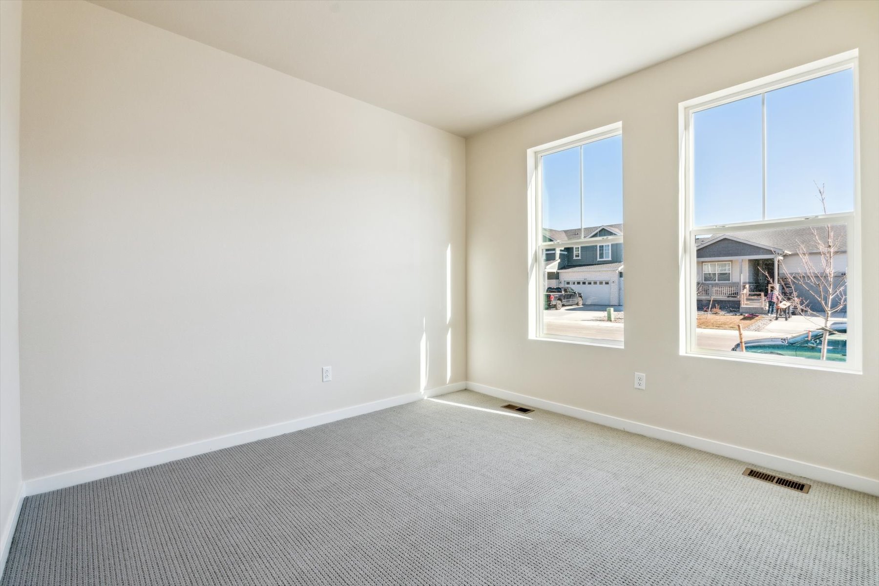 A room with a window and a view of the water.