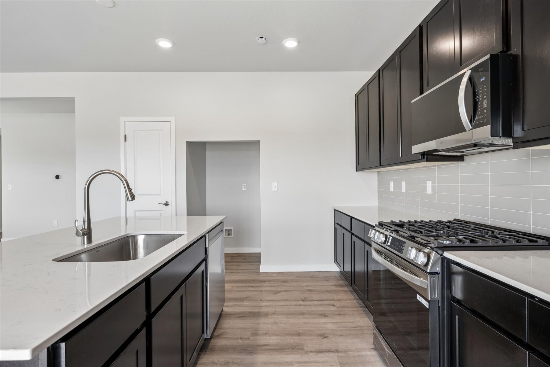 A kitchen with black cabinets.