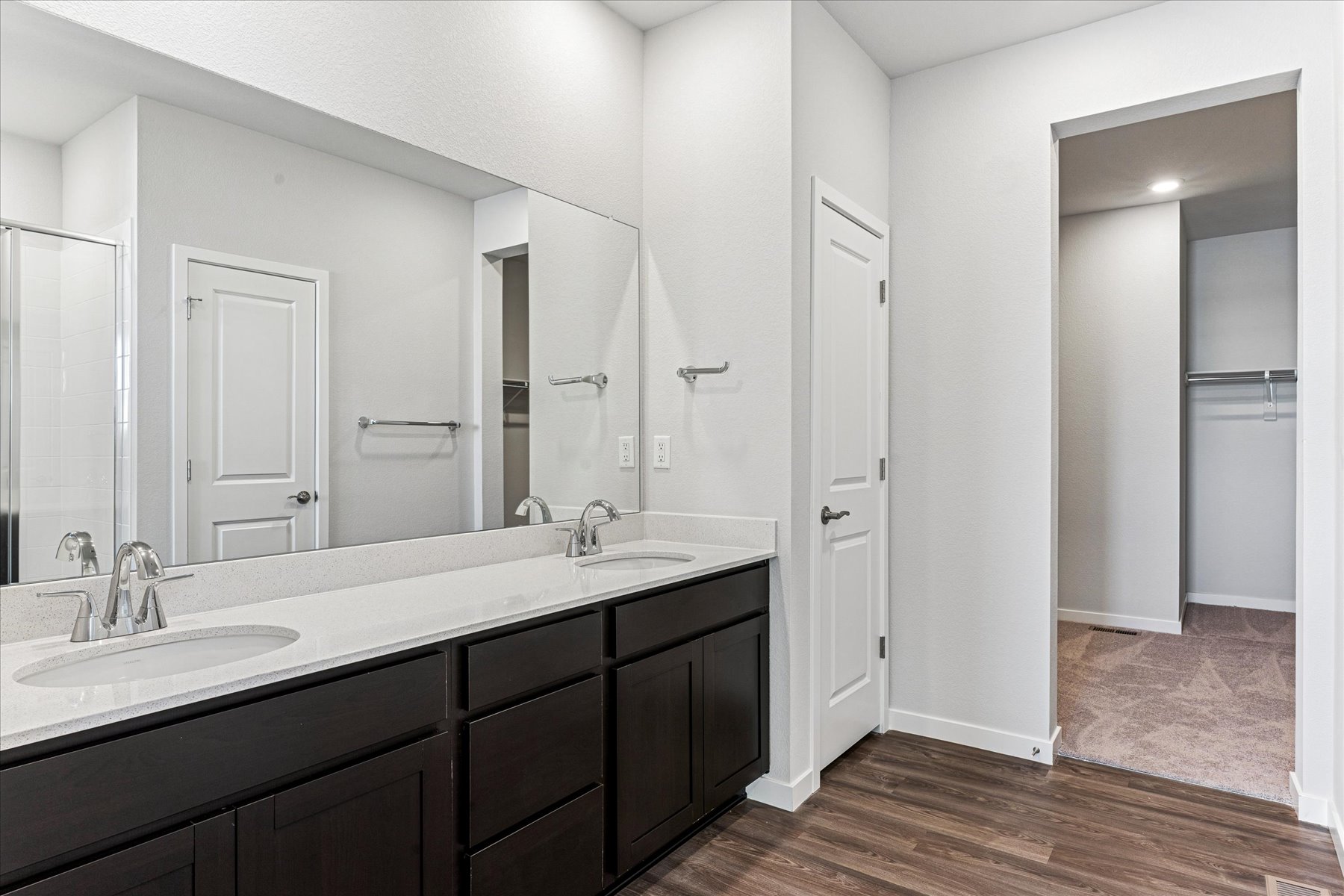 A bathroom with a large mirror.