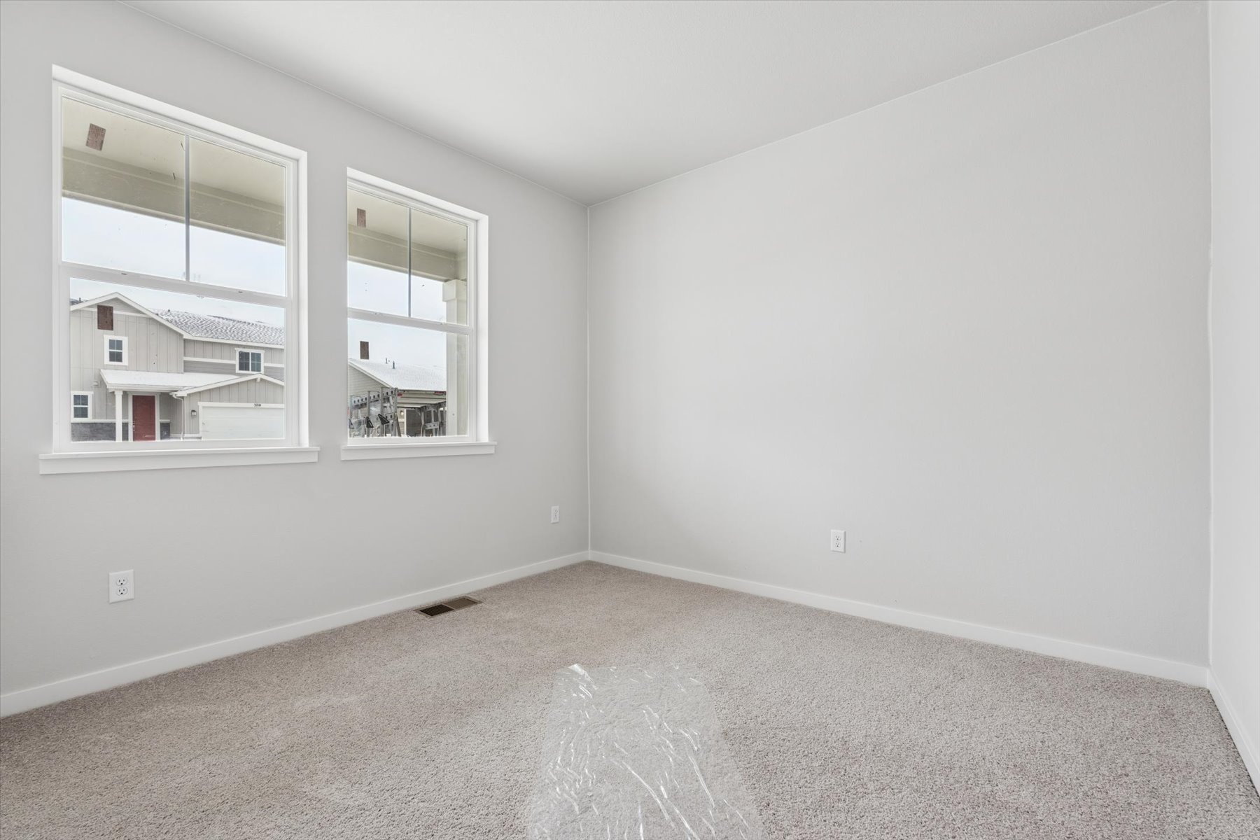 A room with a window and a carpet.