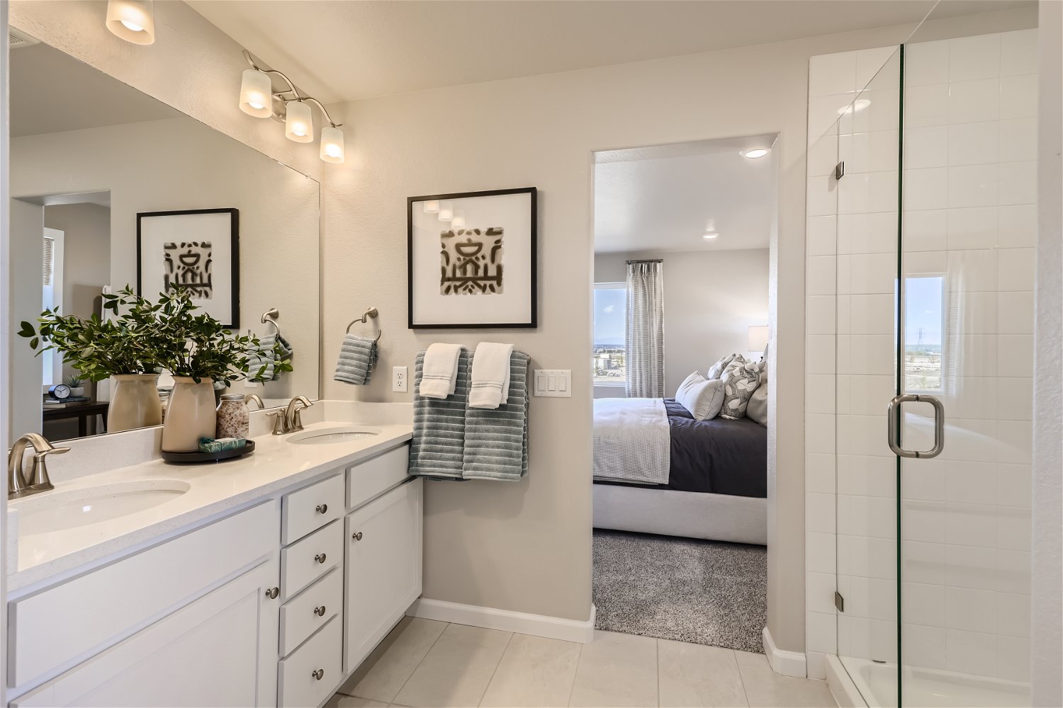 A bathroom with a sink and a bed.