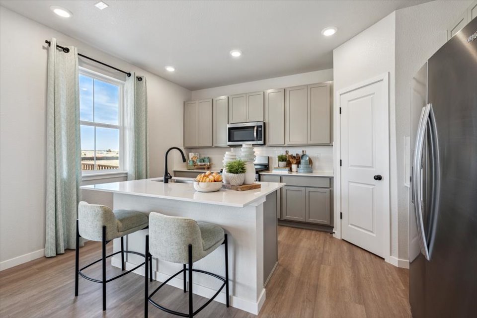 A kitchen with white cabinets.