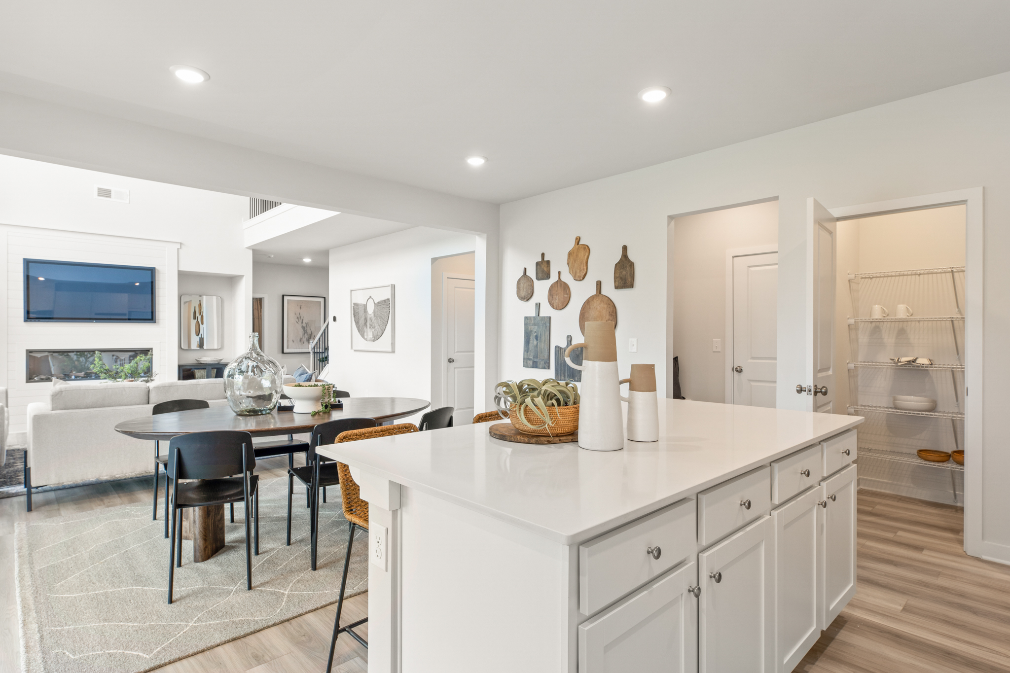 A kitchen with white cabinets.