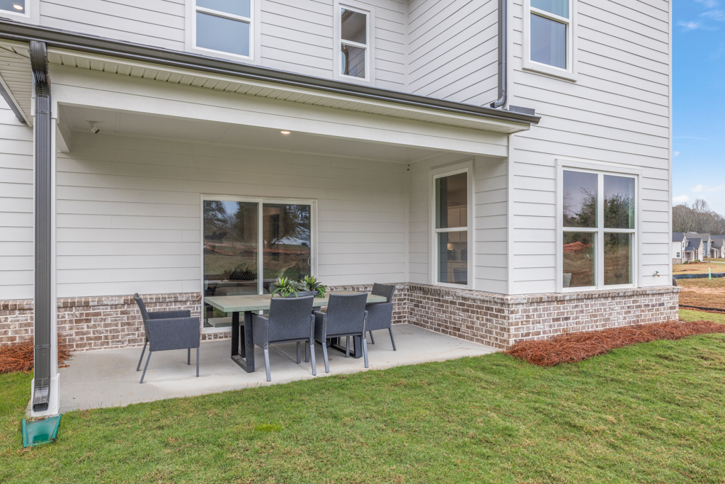 A backyard with a table and chairs.