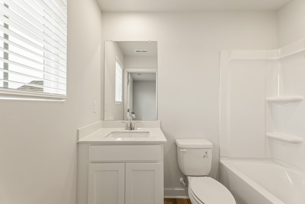 A bathroom with a toilet and sink.