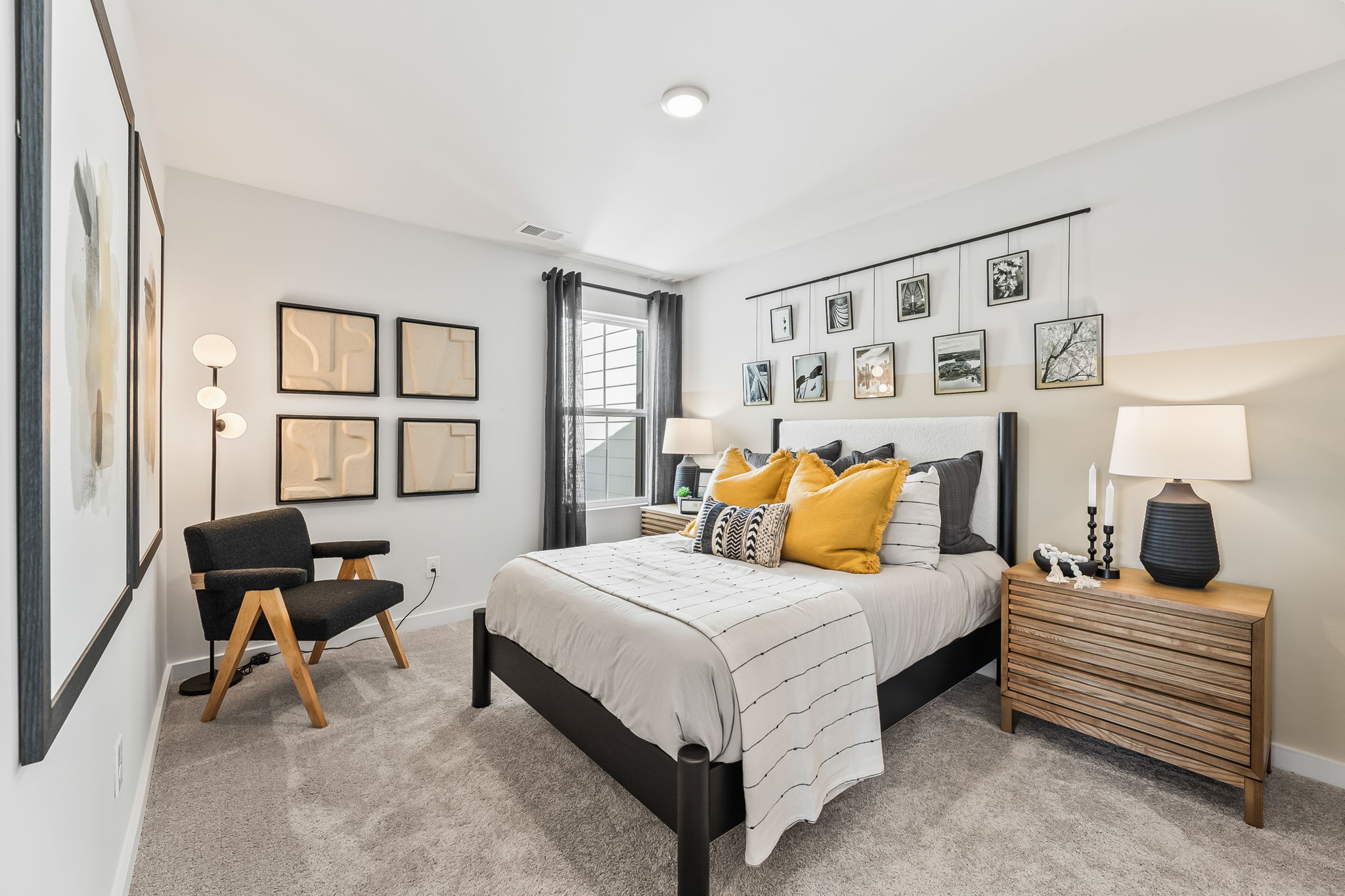 A bedroom with a bed and a chair.