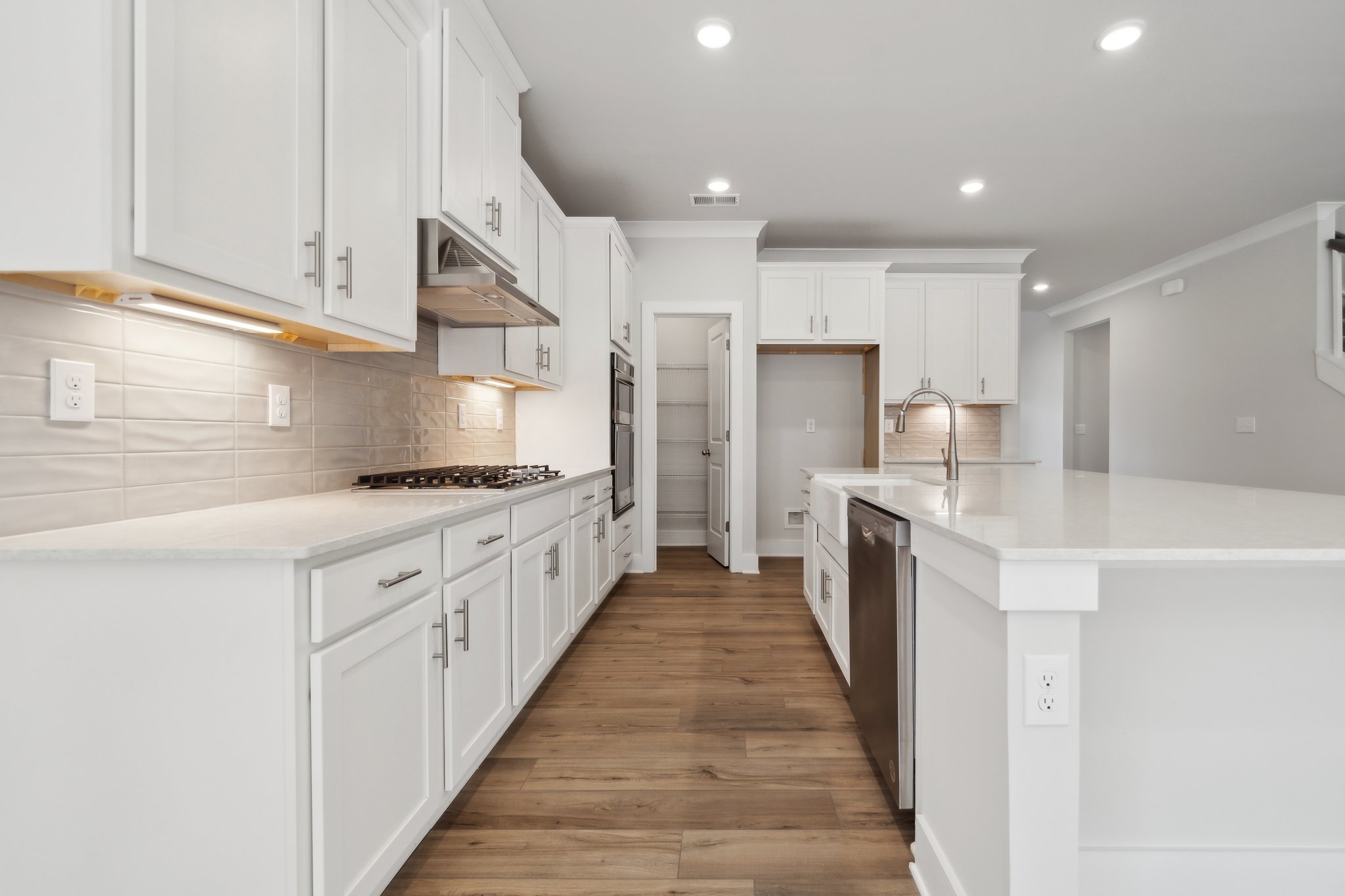 A kitchen with white cabinets.