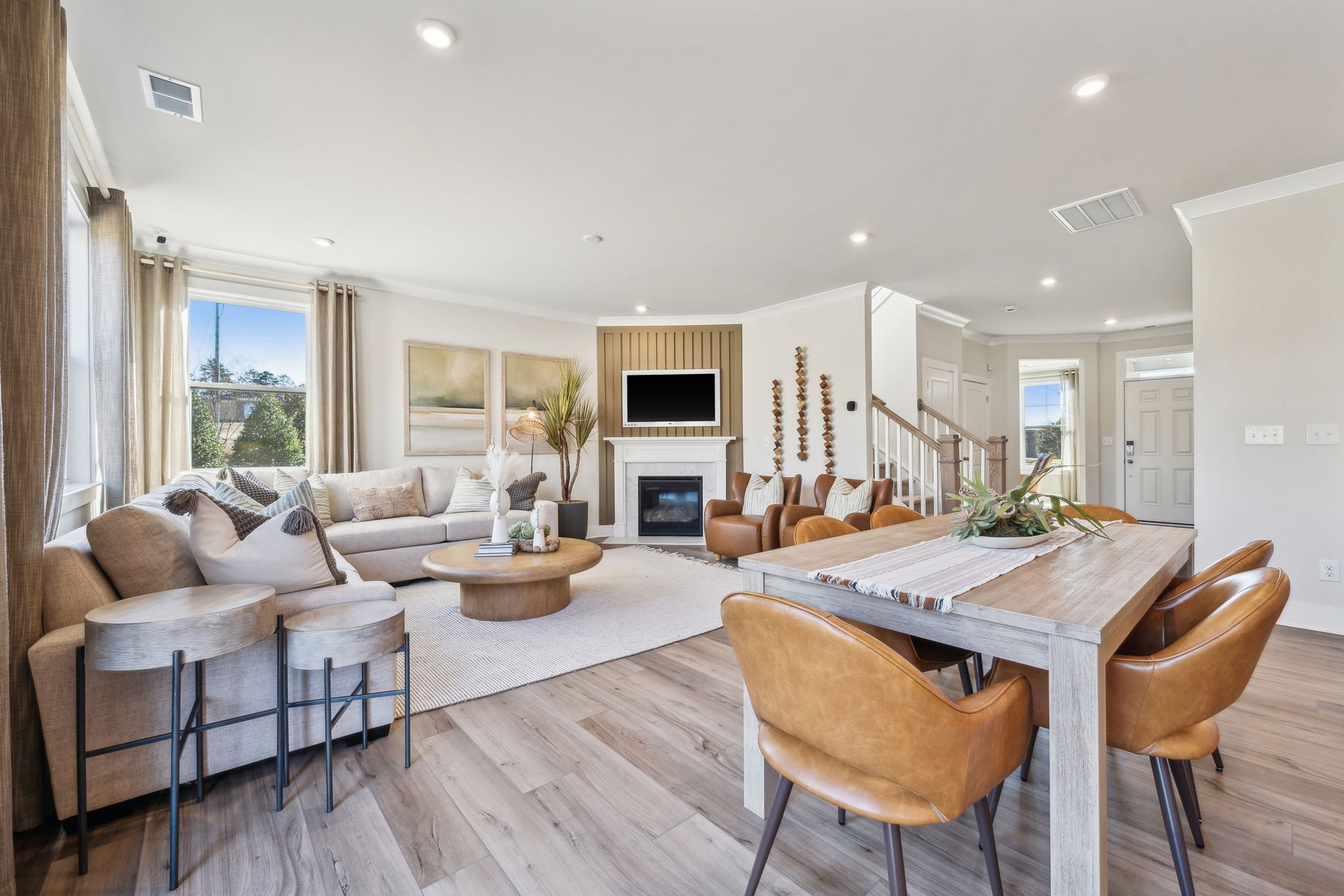 A large living room with a large dining table and a fireplace.