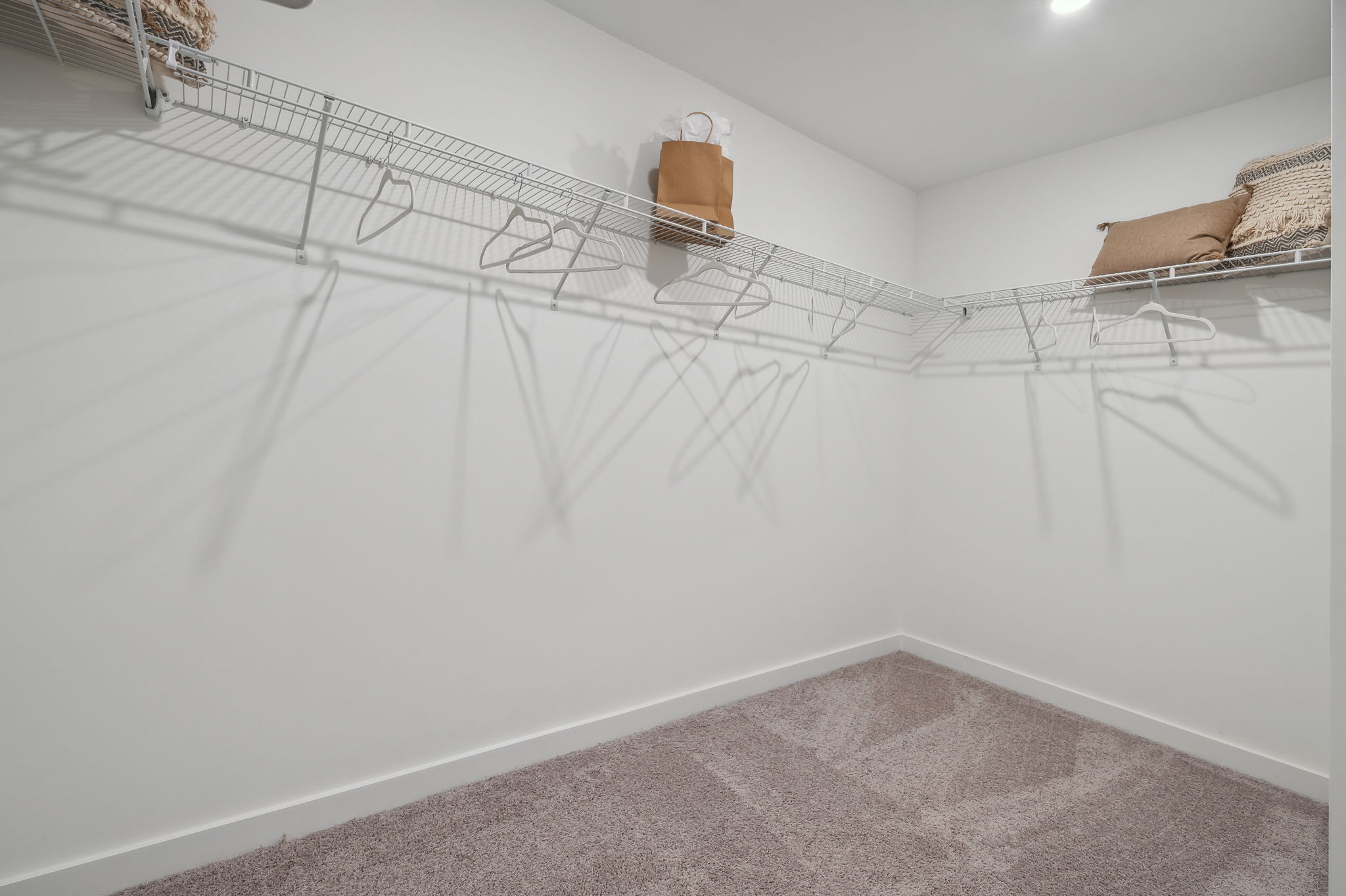 A white bed with a white sheet.