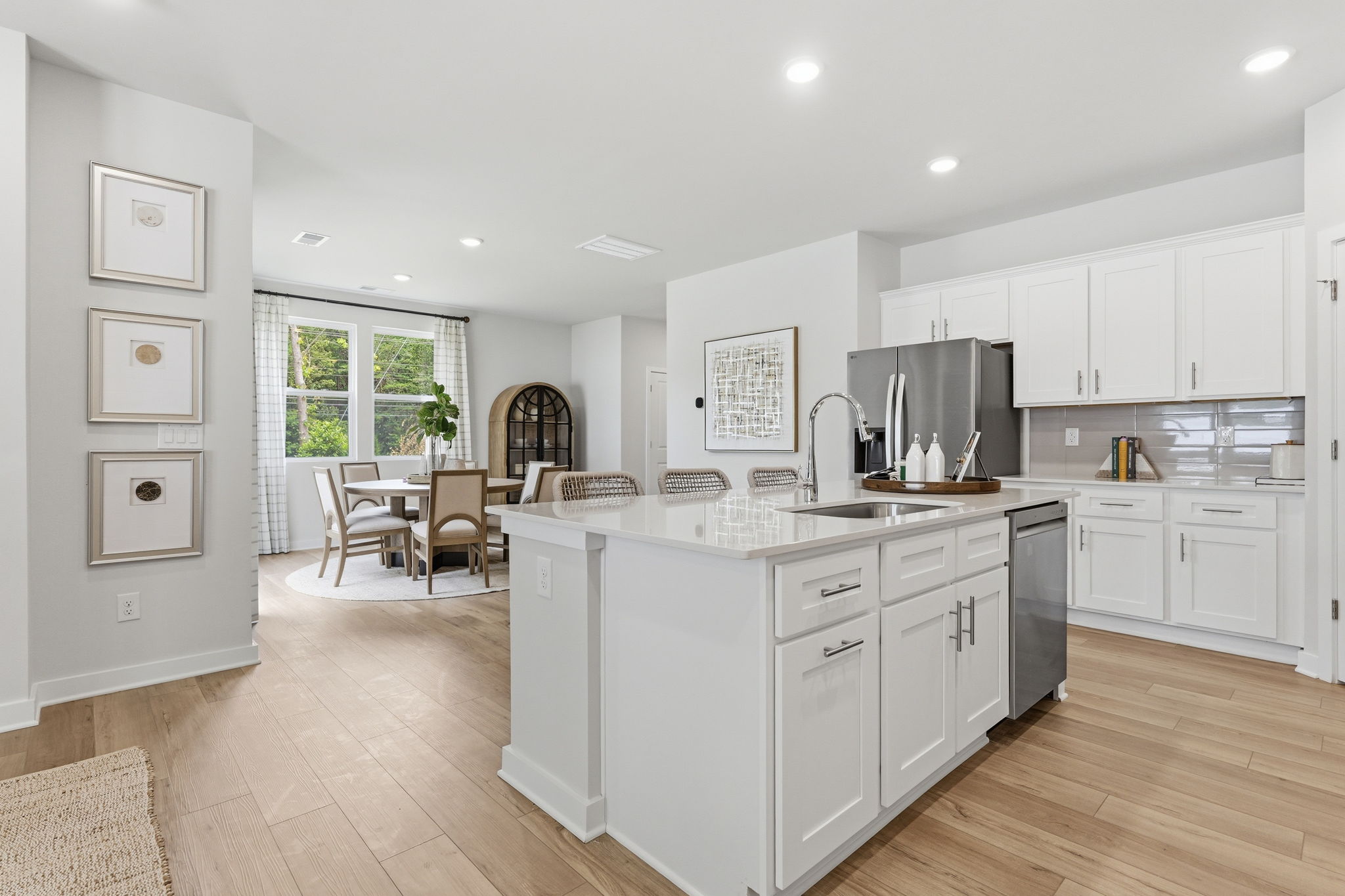 A kitchen with white cabinets.