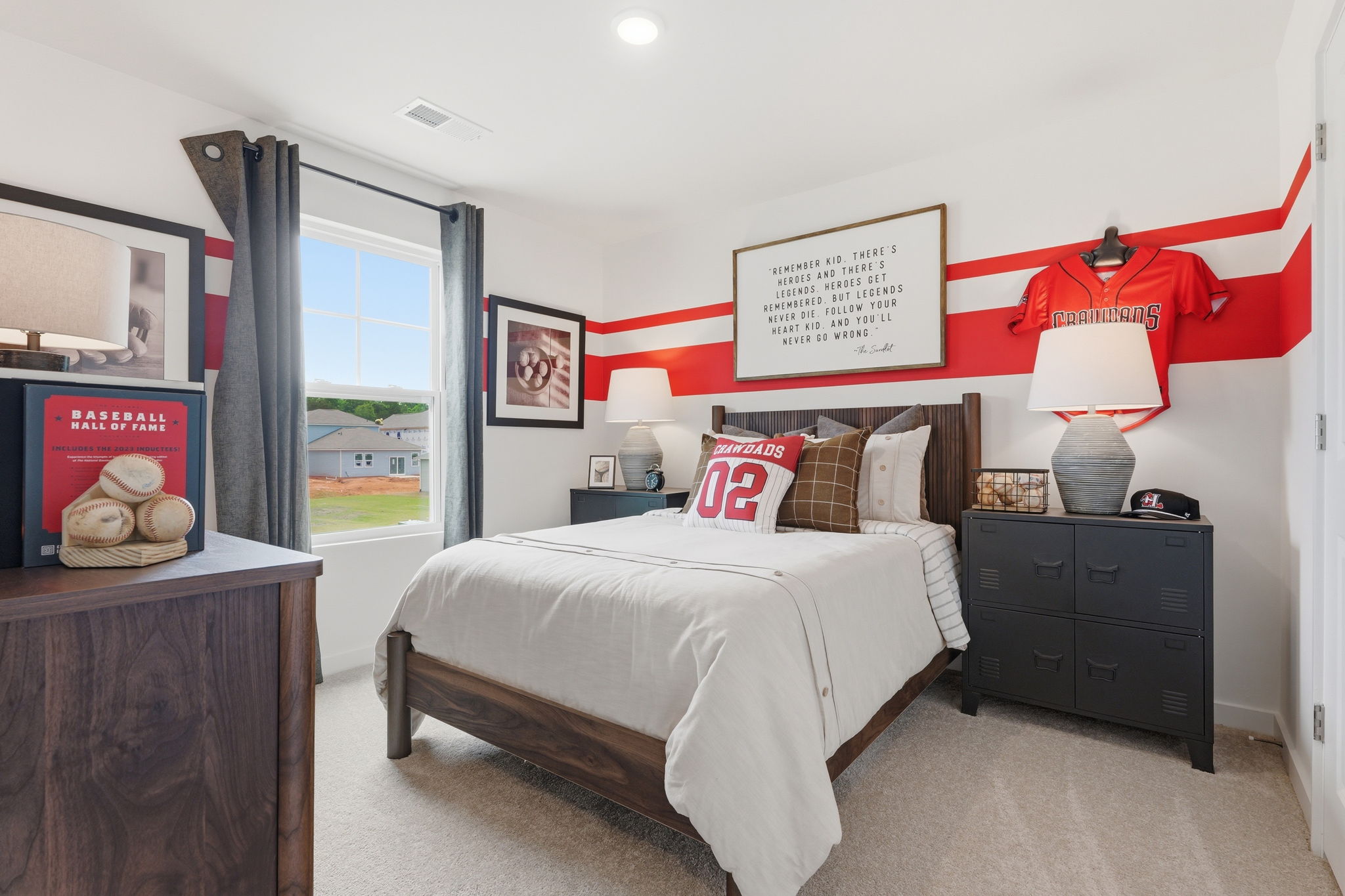 A bedroom with a bed and dresser.
