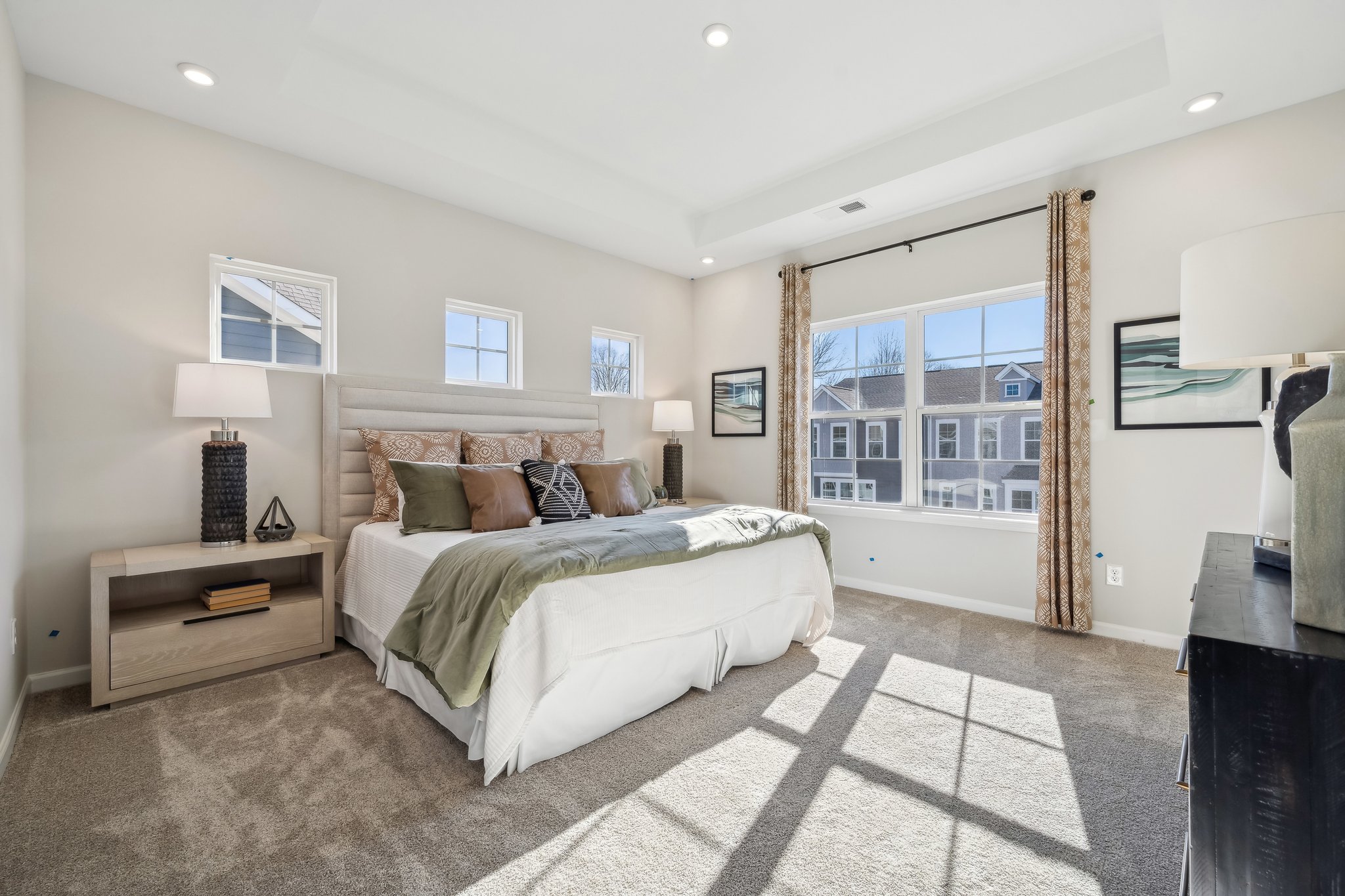 A bedroom with a large window.