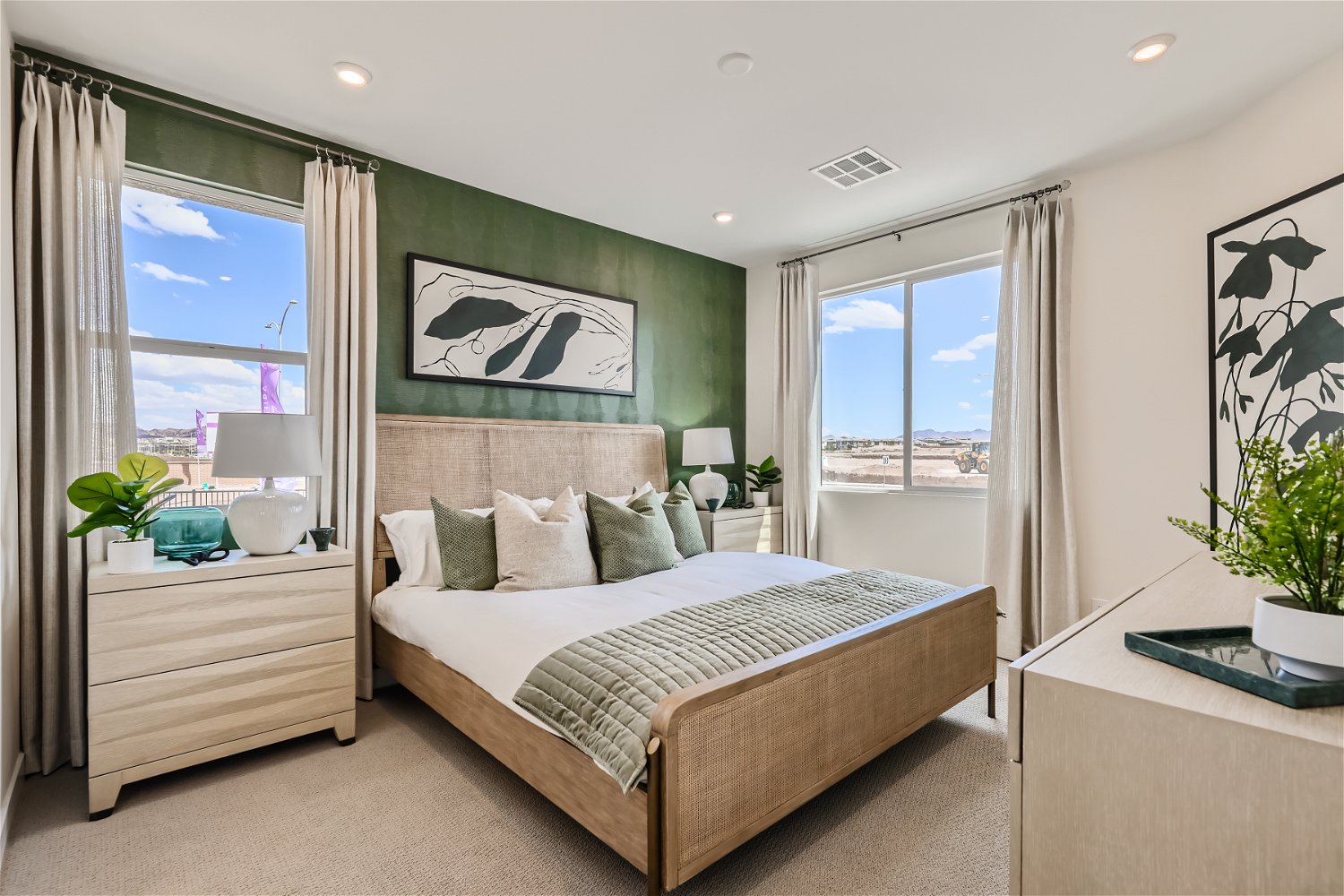 A bedroom with a large window.