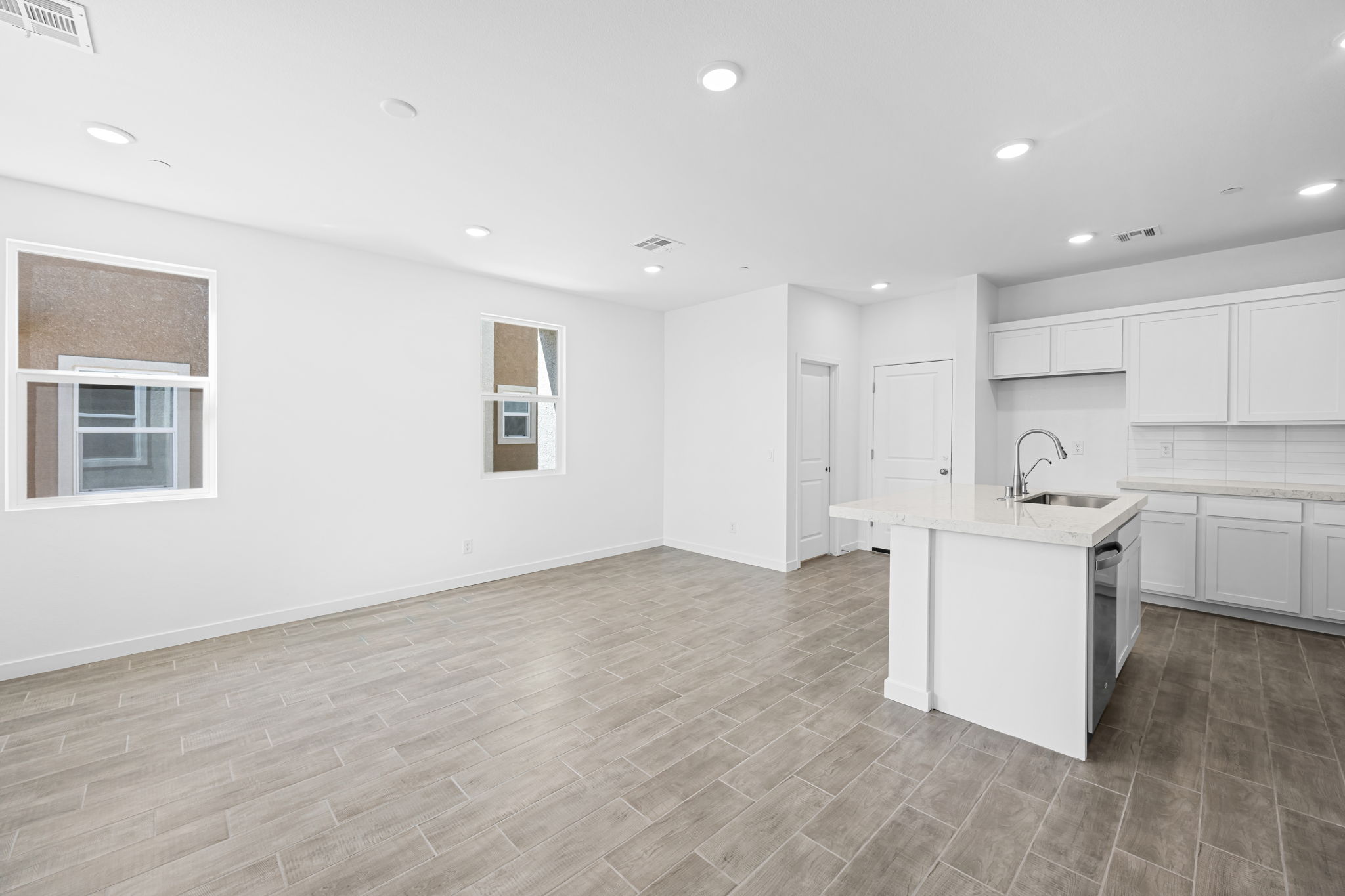 A kitchen with white cabinets.