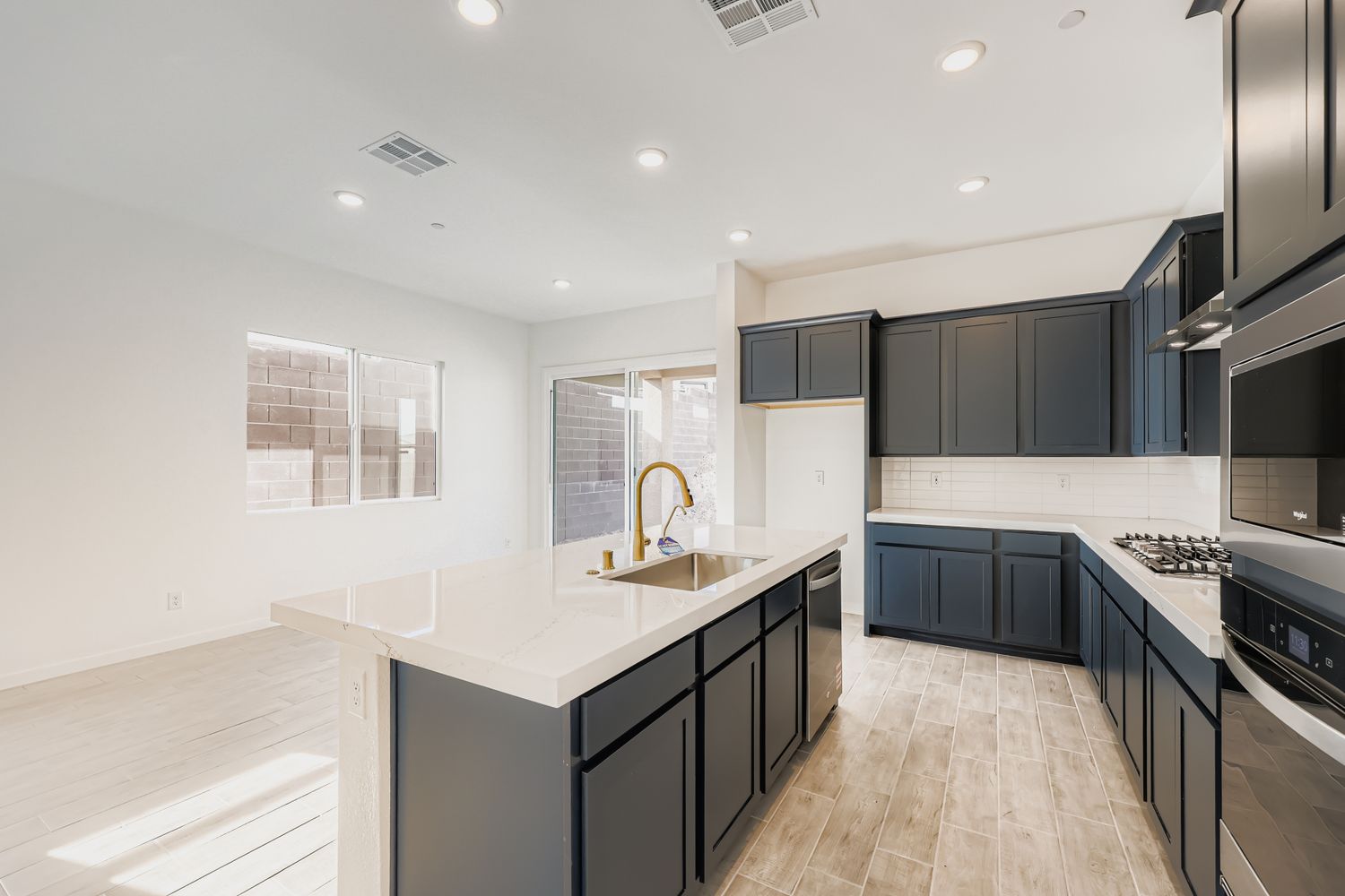 A kitchen with black cabinets.