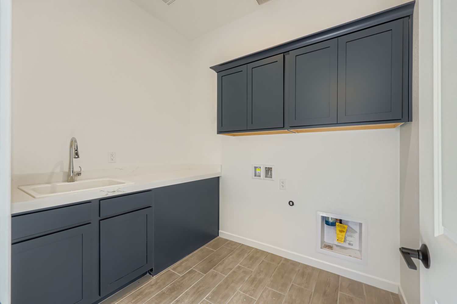 A bathroom with black cabinets.