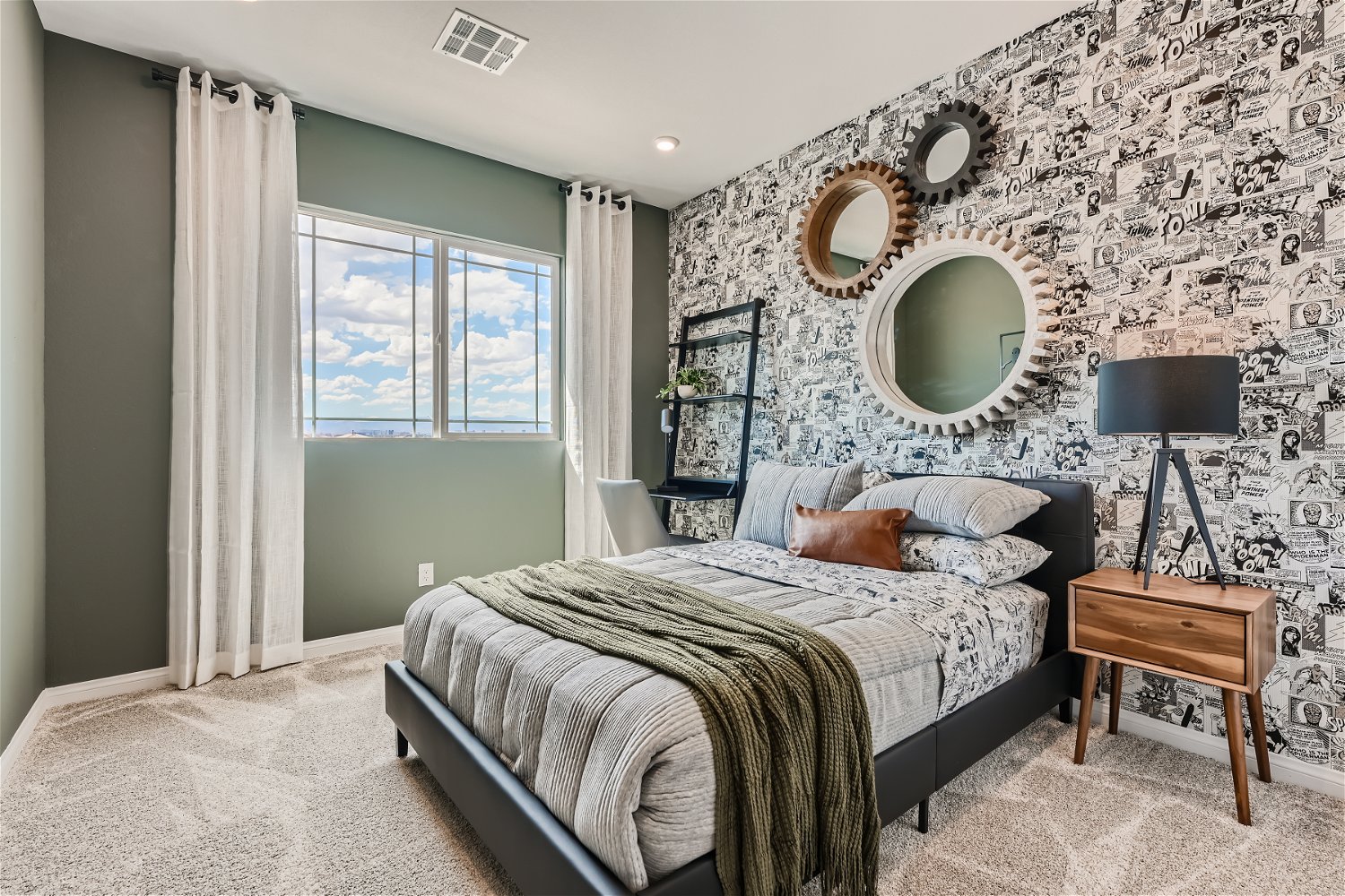 A bedroom with a bed and a lamp.