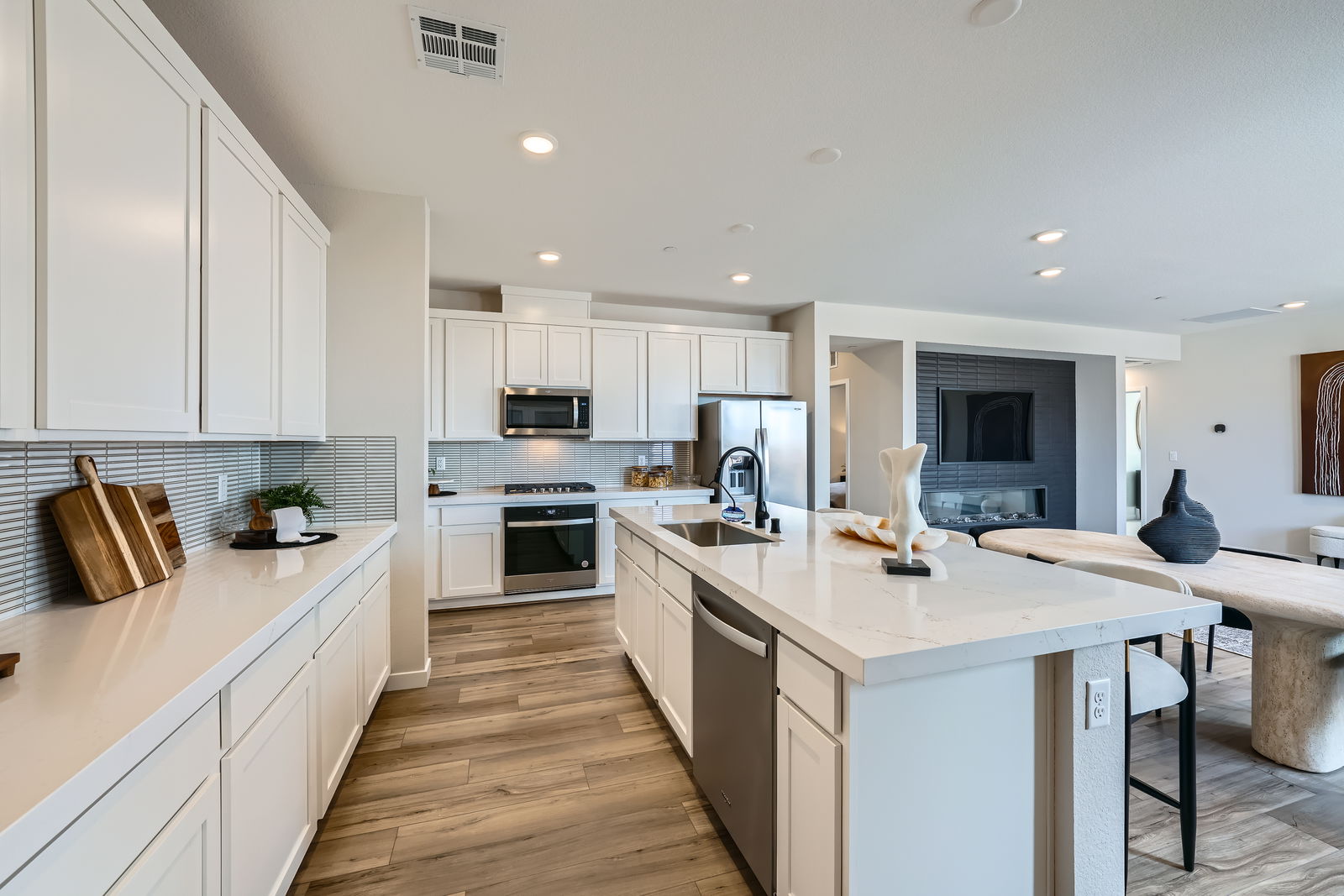 A kitchen with white cabinets.