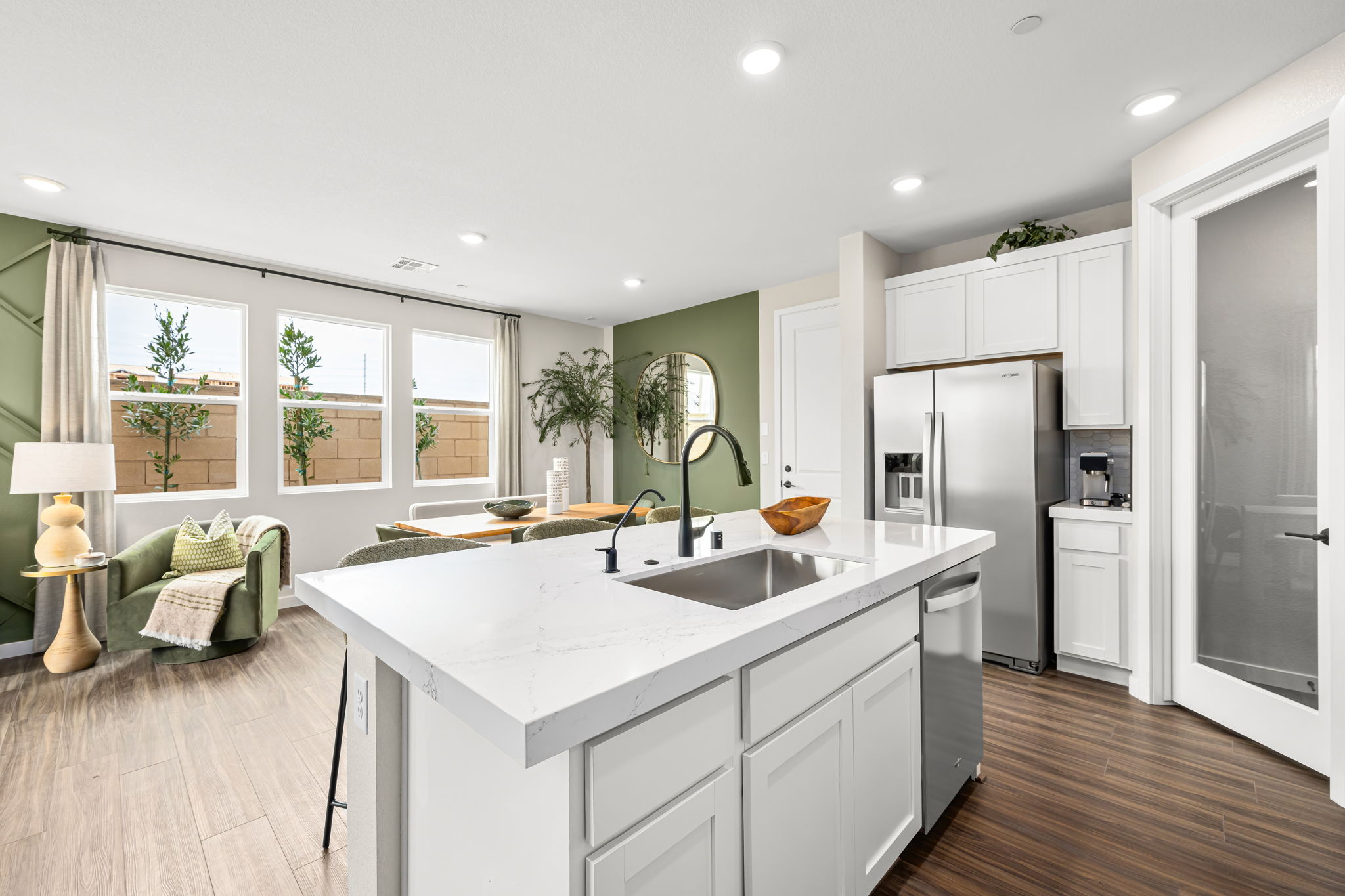 A kitchen with white cabinets.