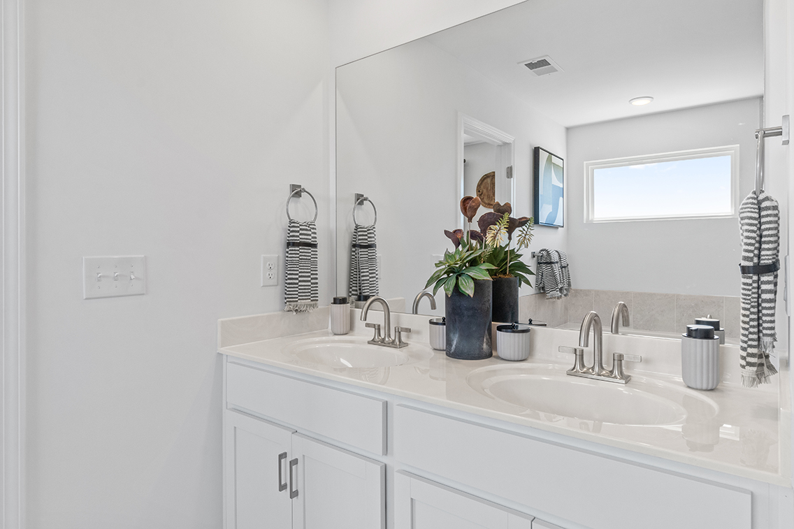 A person taking a selfie in the bathroom mirror.