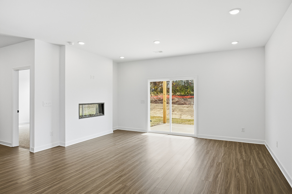 A room with a wood floor and a glass door.