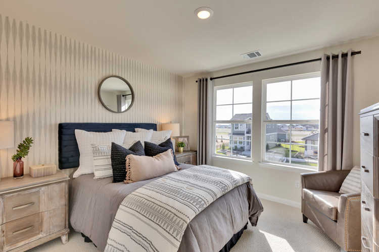 A bedroom with a large window.