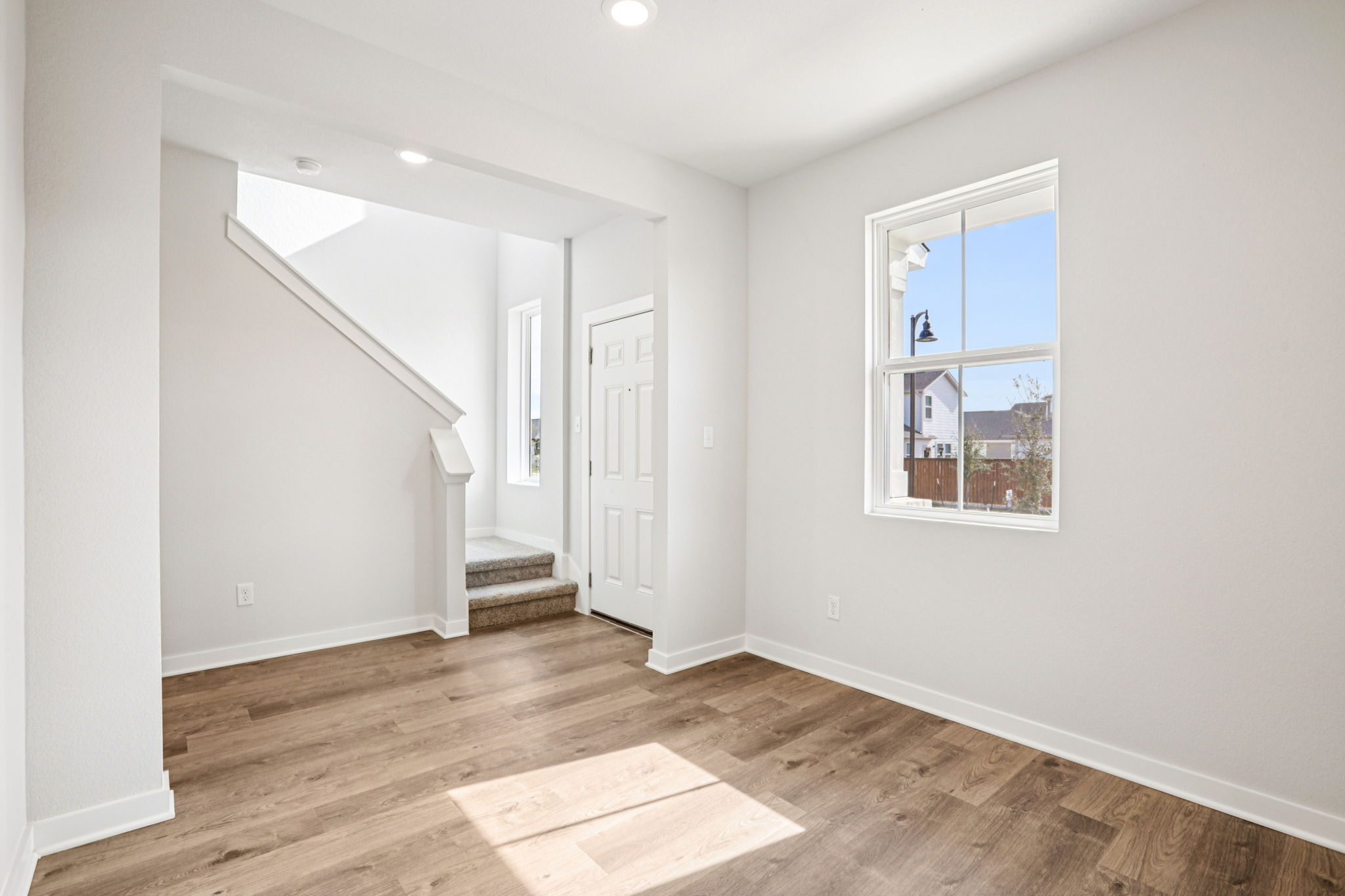 A room with a wood floor and a window.