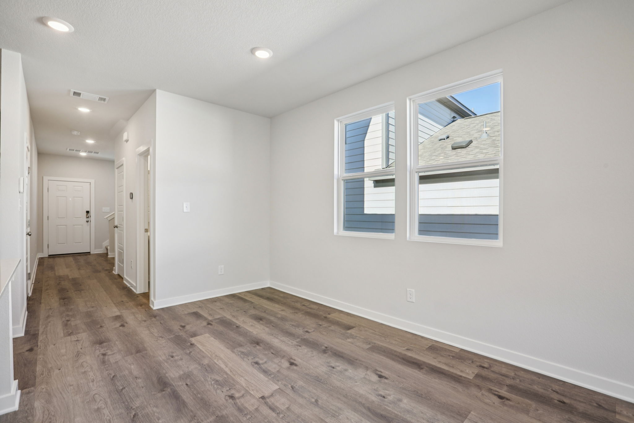 A room with white walls and a wood floor.