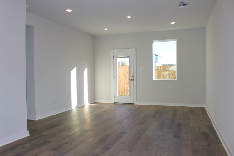 A room with white walls and a wood floor.