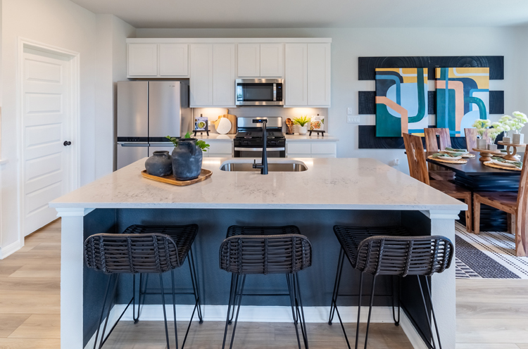 A kitchen with a table and chairs.