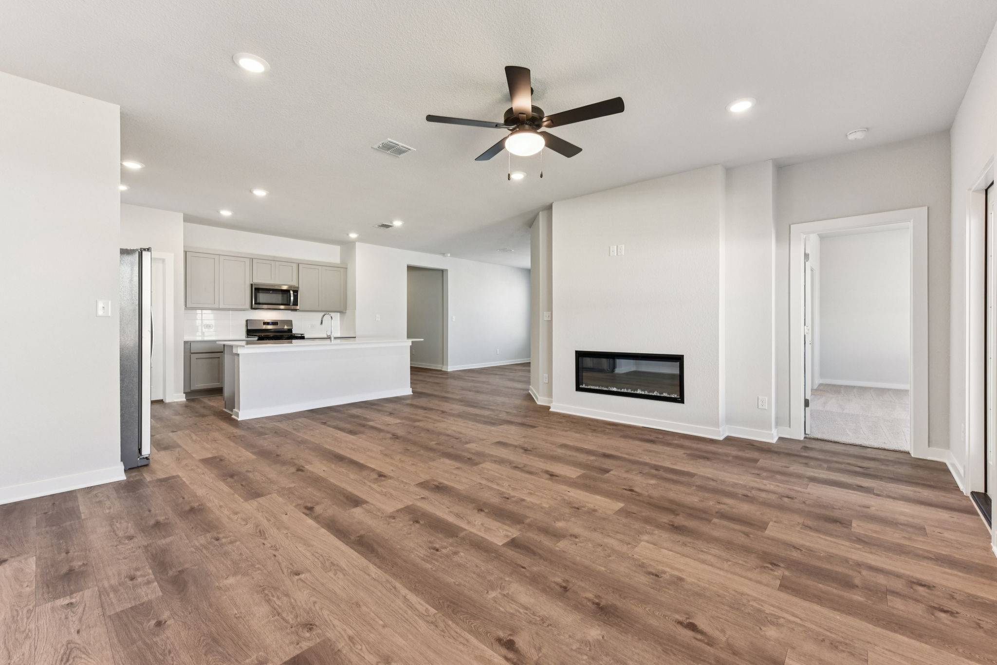 A large kitchen with a wood floor.