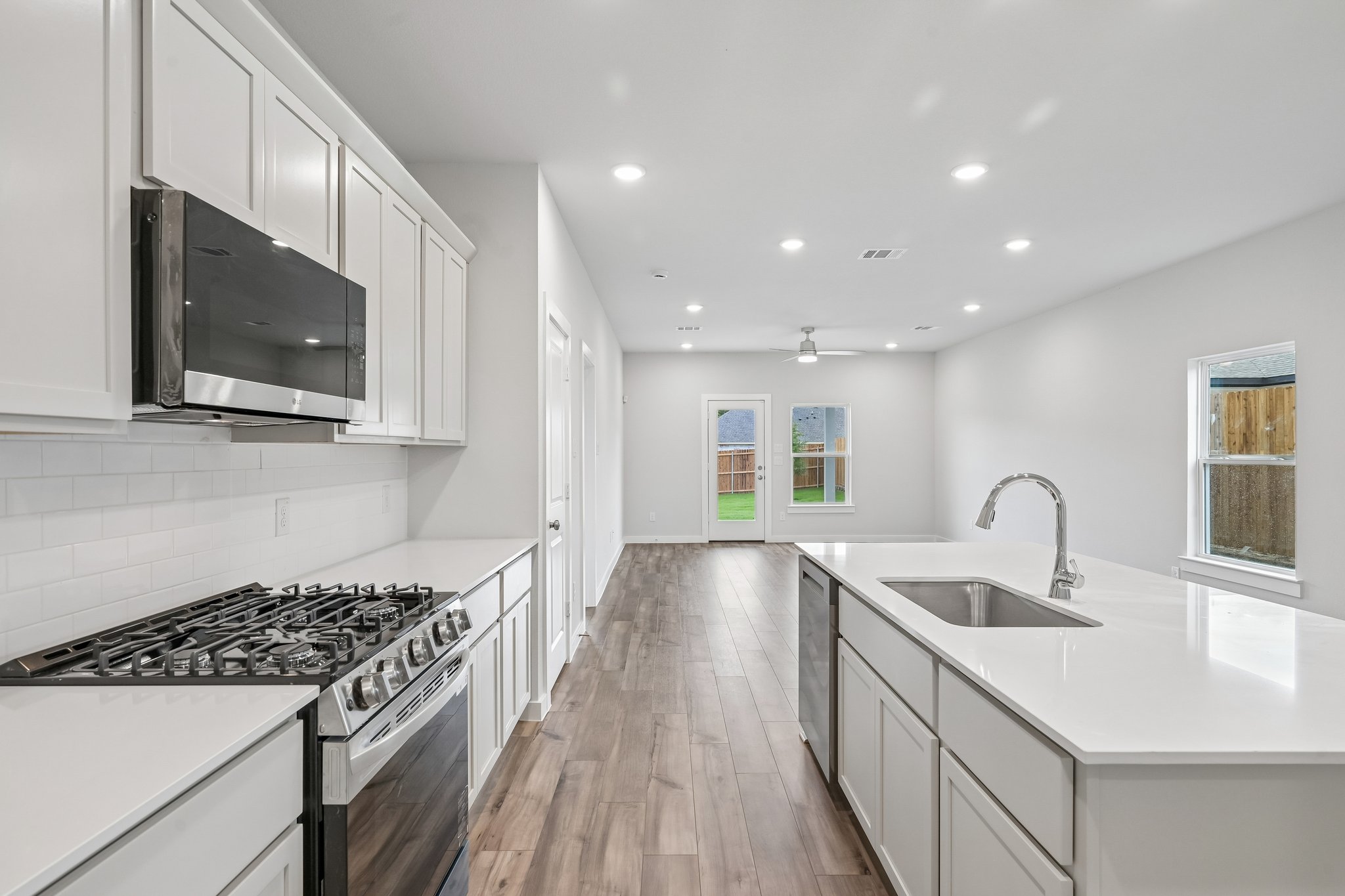 A kitchen with white cabinets.