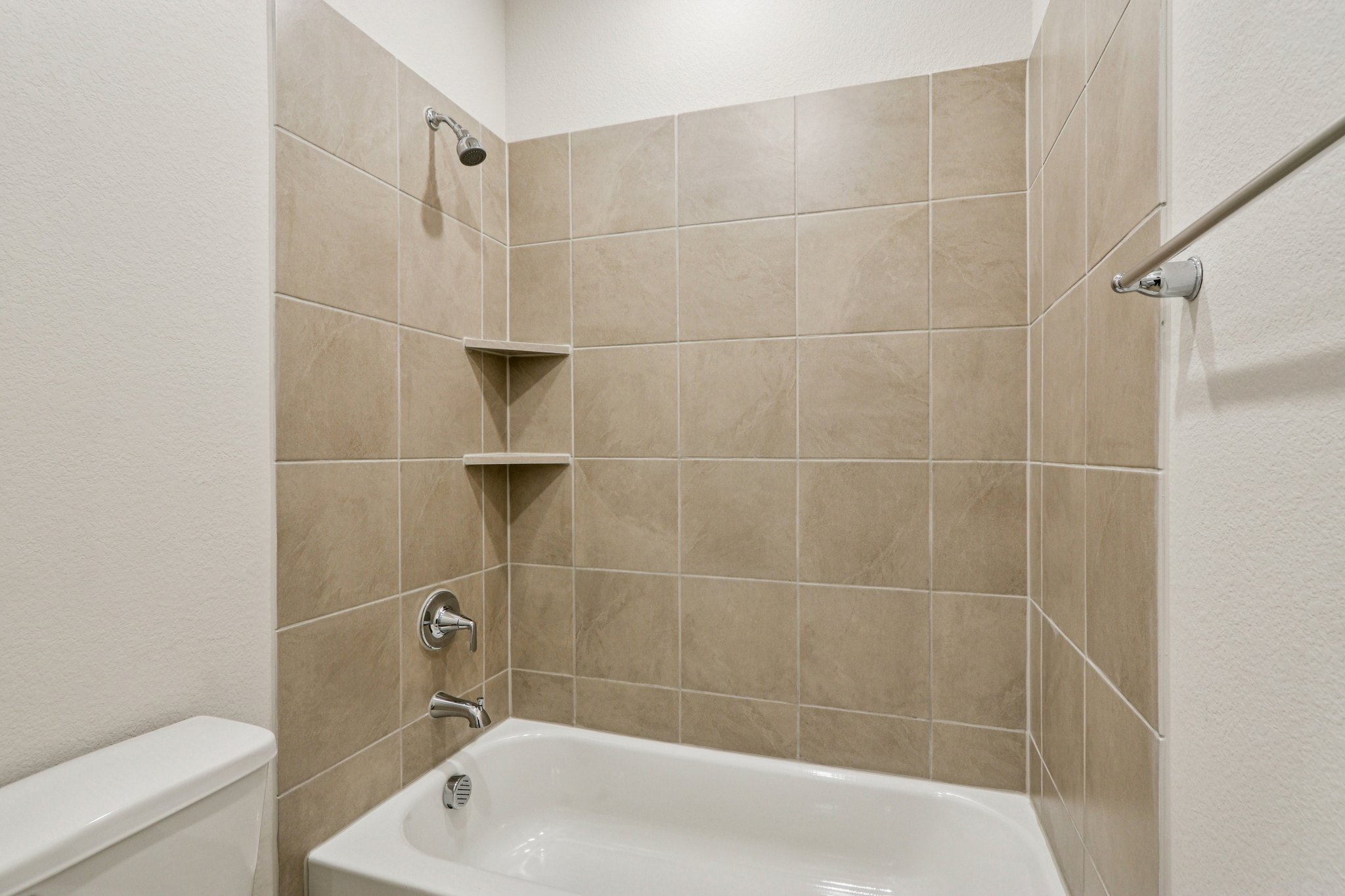 A bathtub in a bathroom.