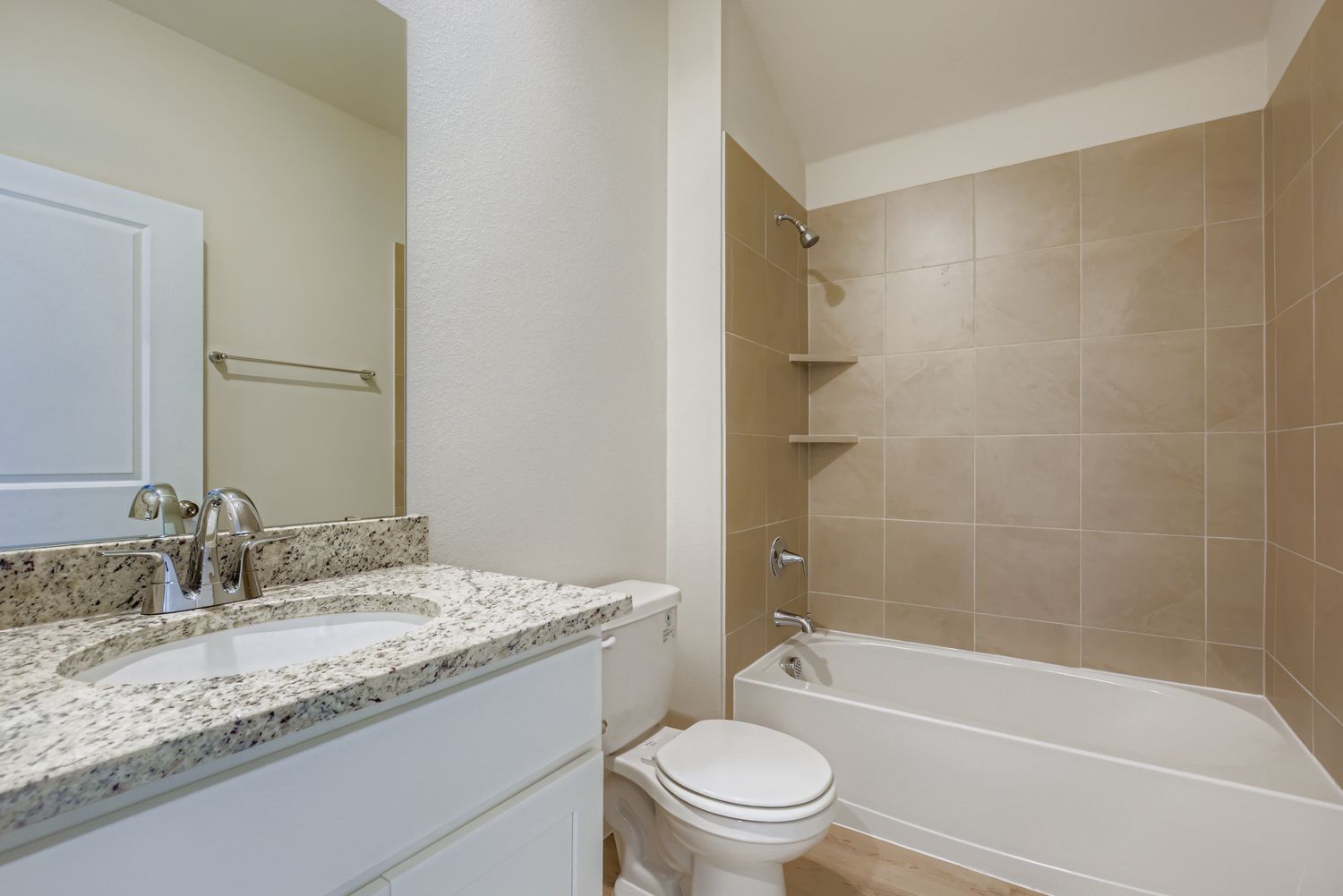 A bathroom with a tub sink and toilet.