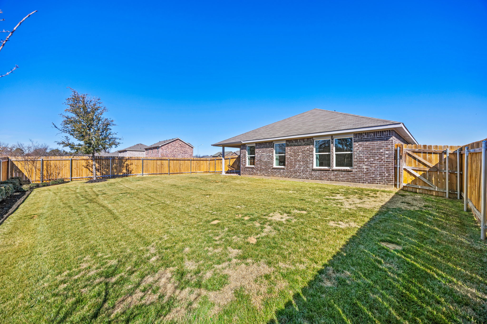 A house with a fence and grass.