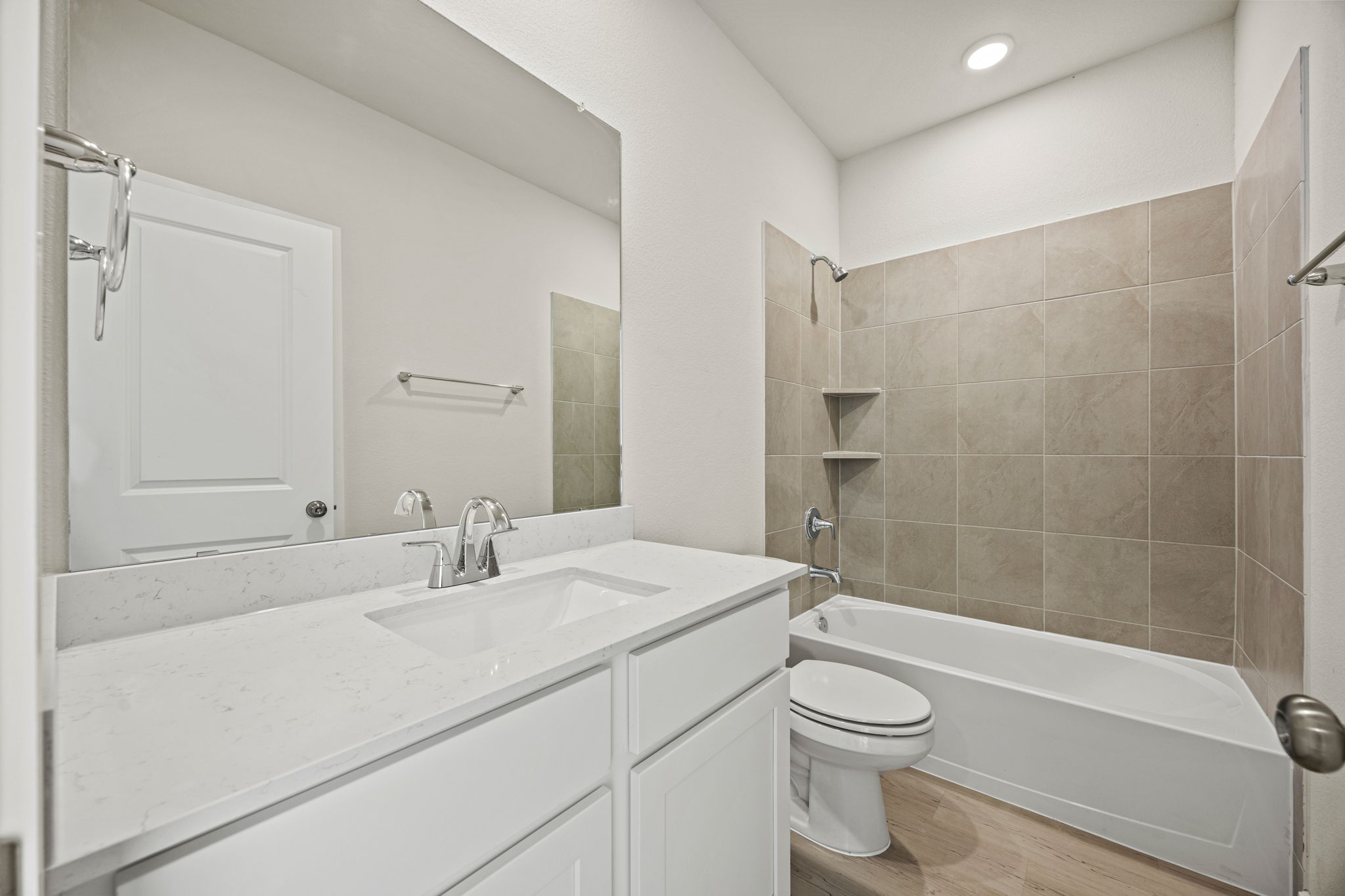 A bathroom with a tub sink and toilet.
