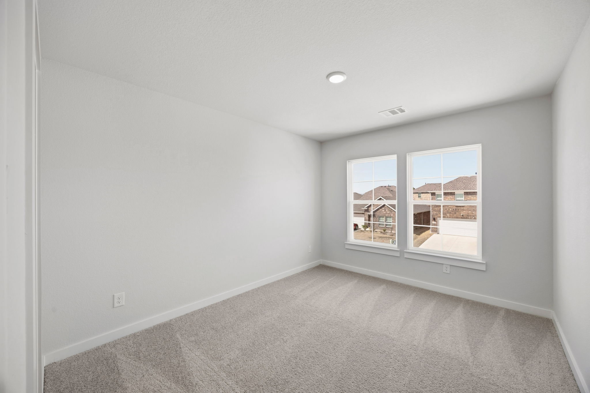 A room with a window and a carpet.