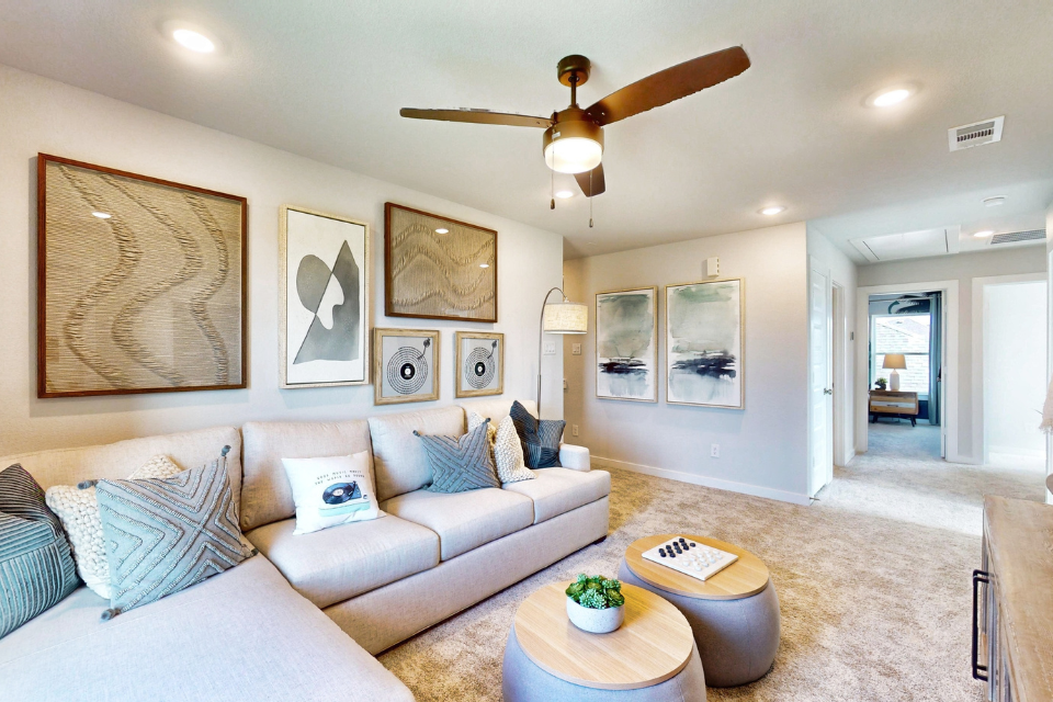 A living room with a ceiling fan.