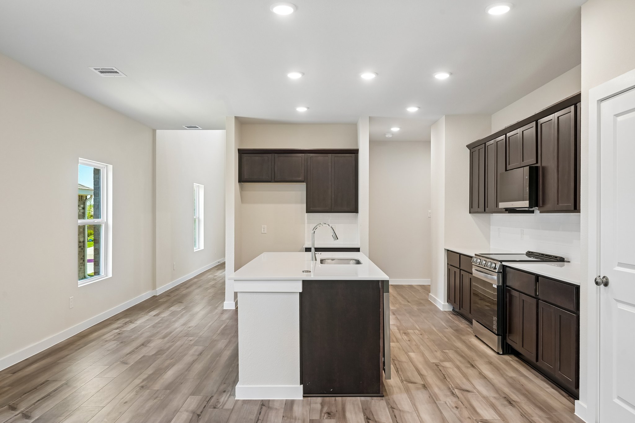 A kitchen with black cabinets.