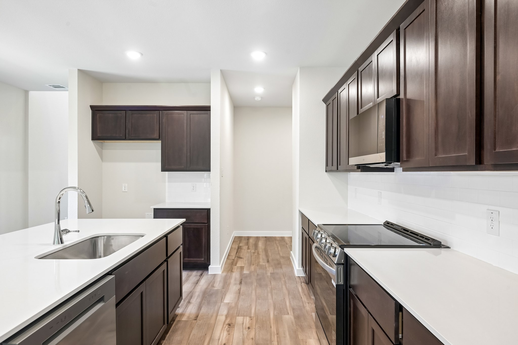 A kitchen with black cabinets.