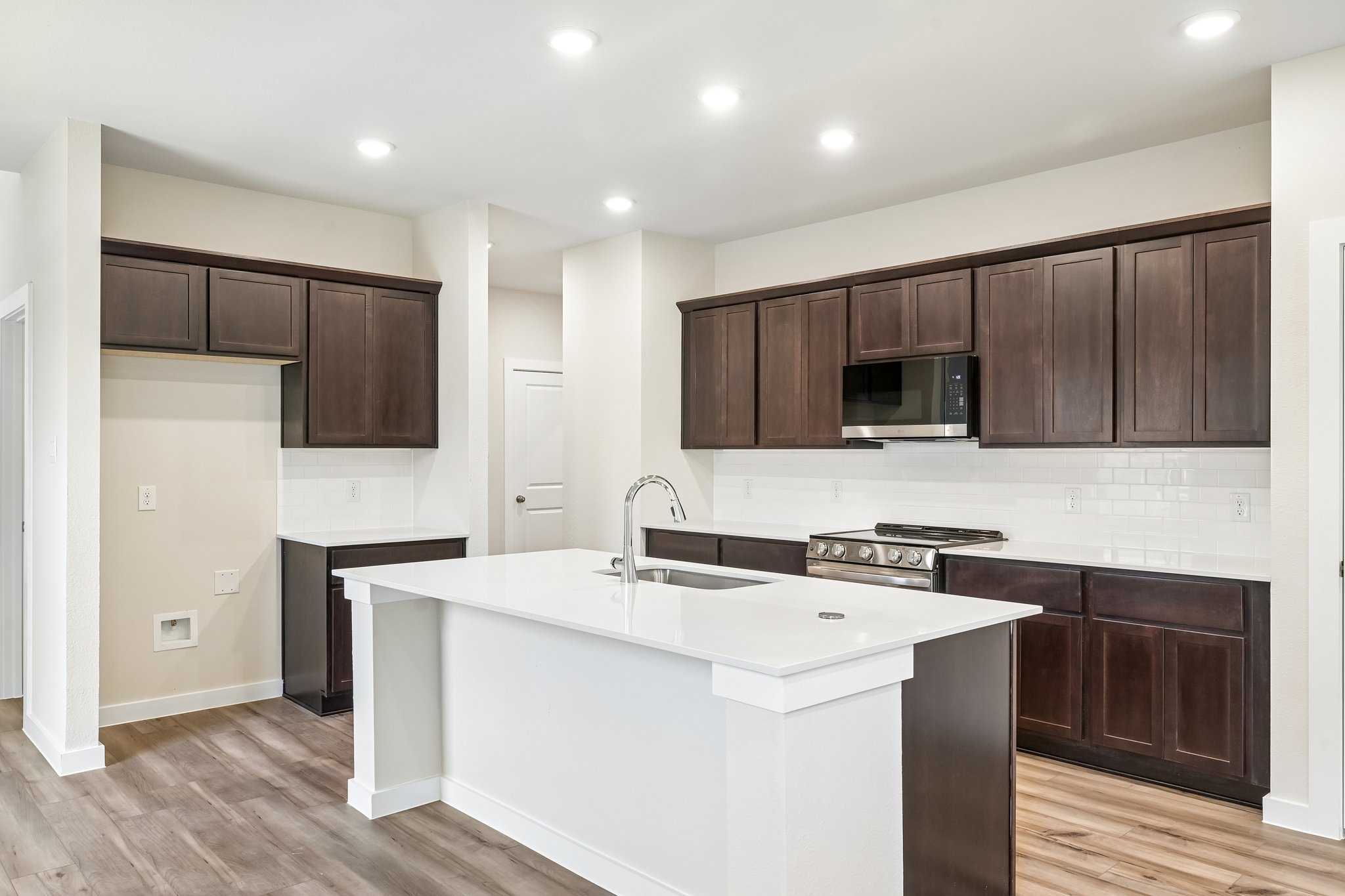 A kitchen with wooden cabinets.