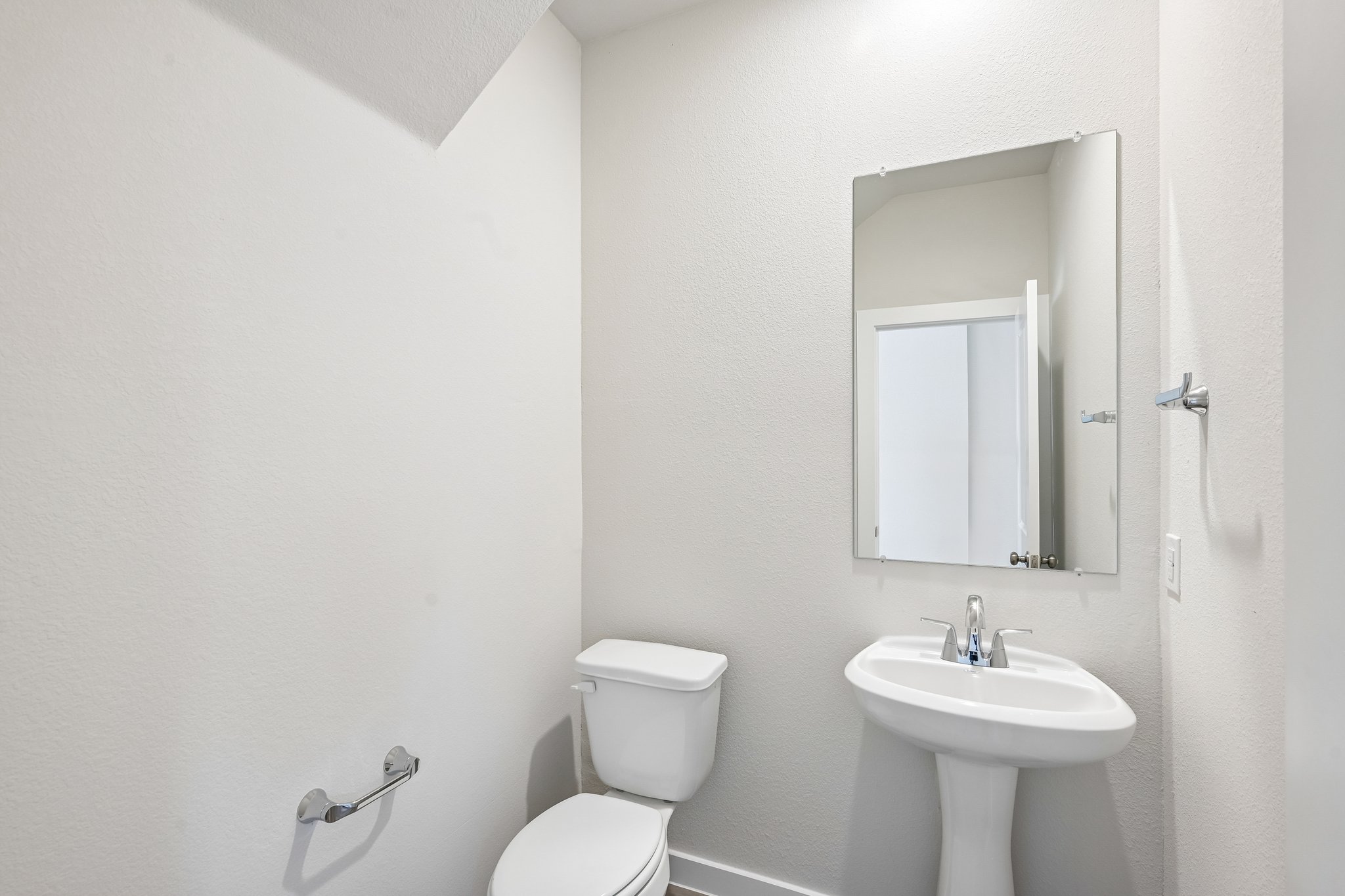 A bathroom with a sink and toilet.