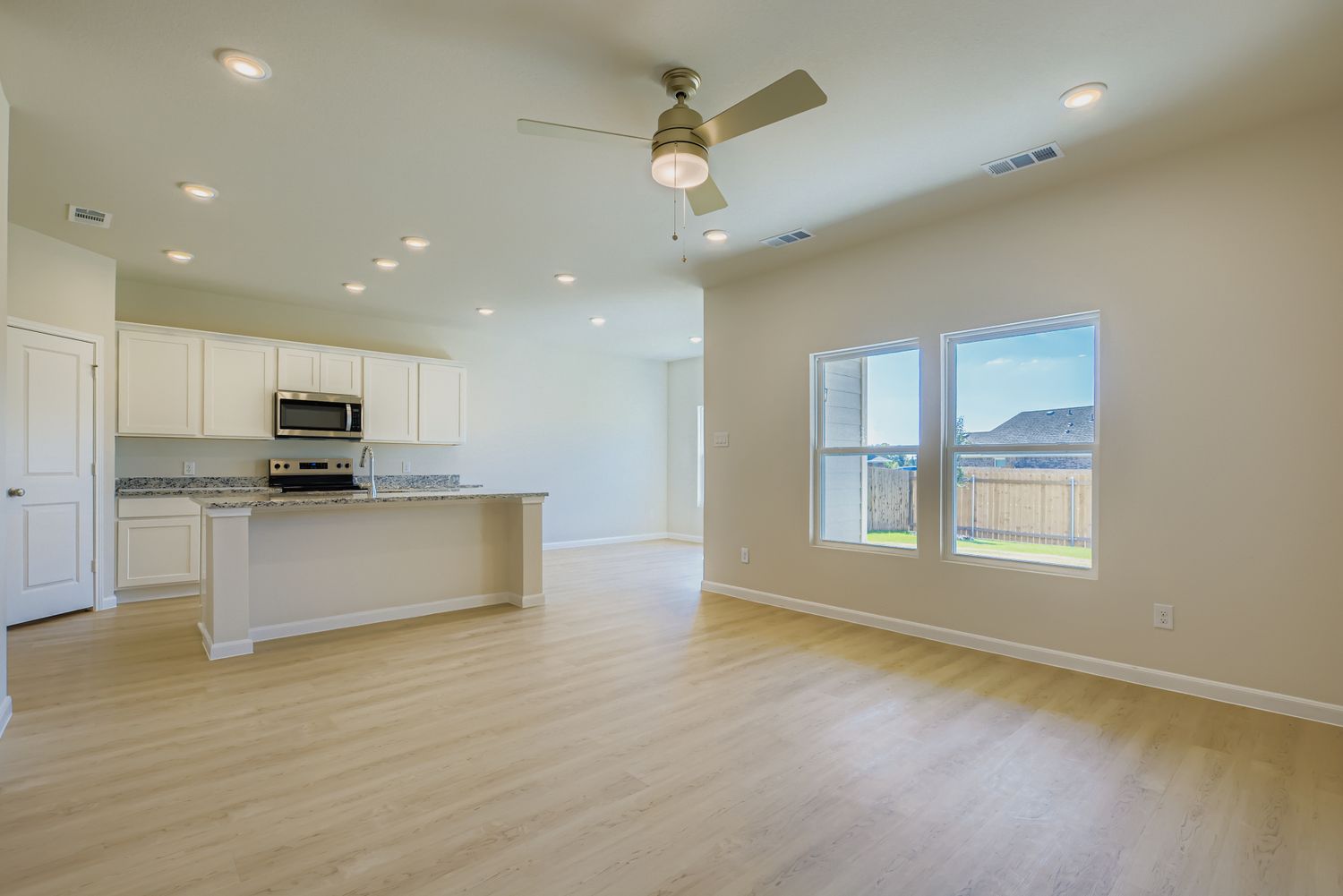 A large kitchen with white cabinets.