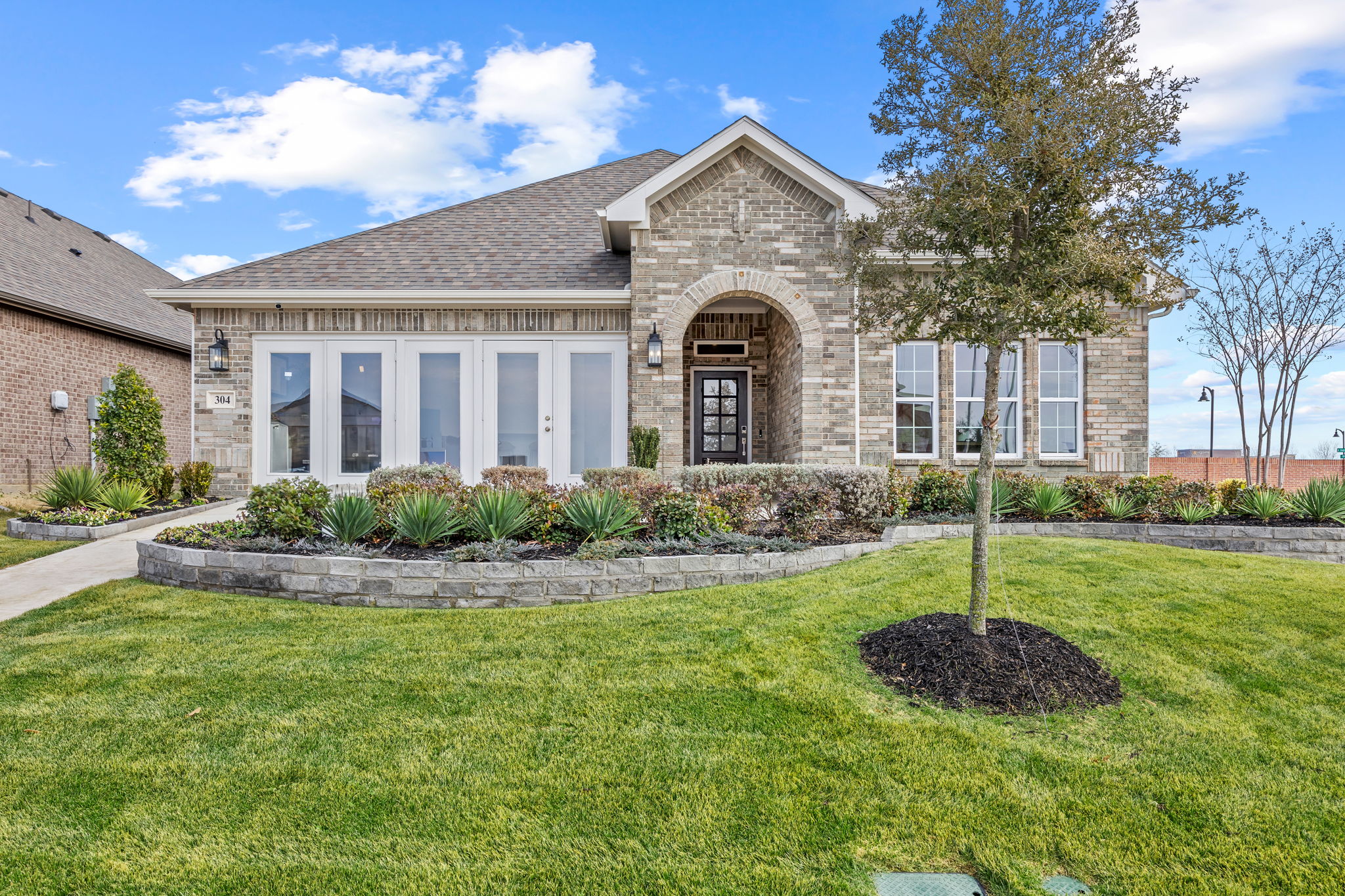 A large house with a large front yard.