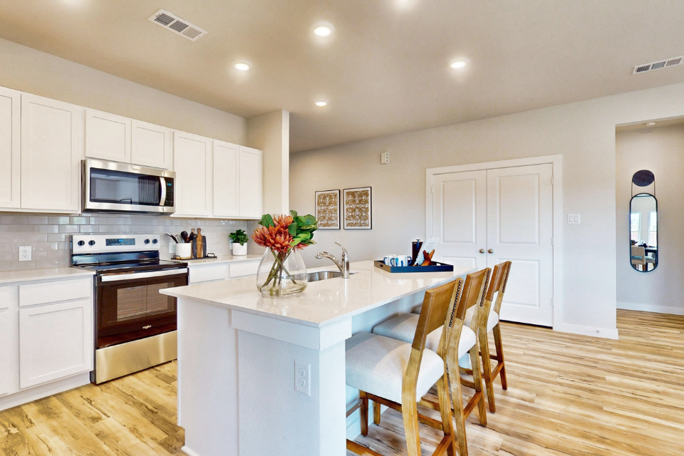 A kitchen with white cabinets.