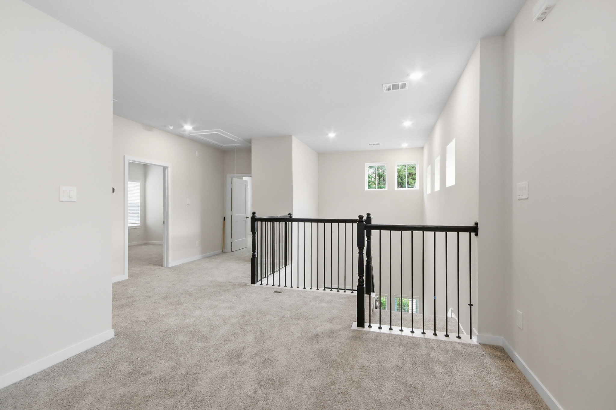 A hallway with a railing.