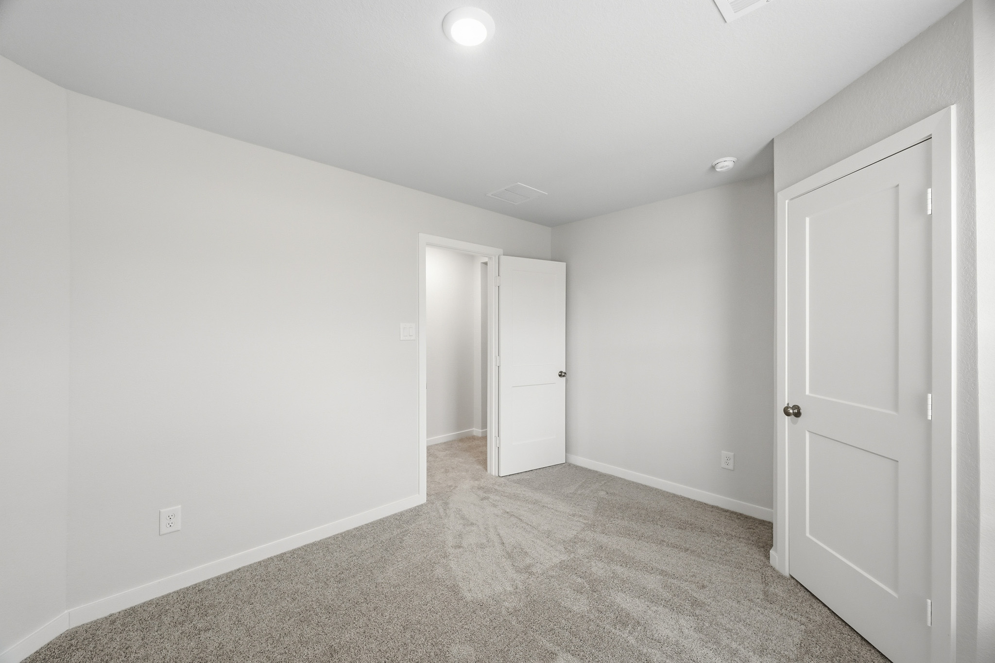 A hallway with white doors.