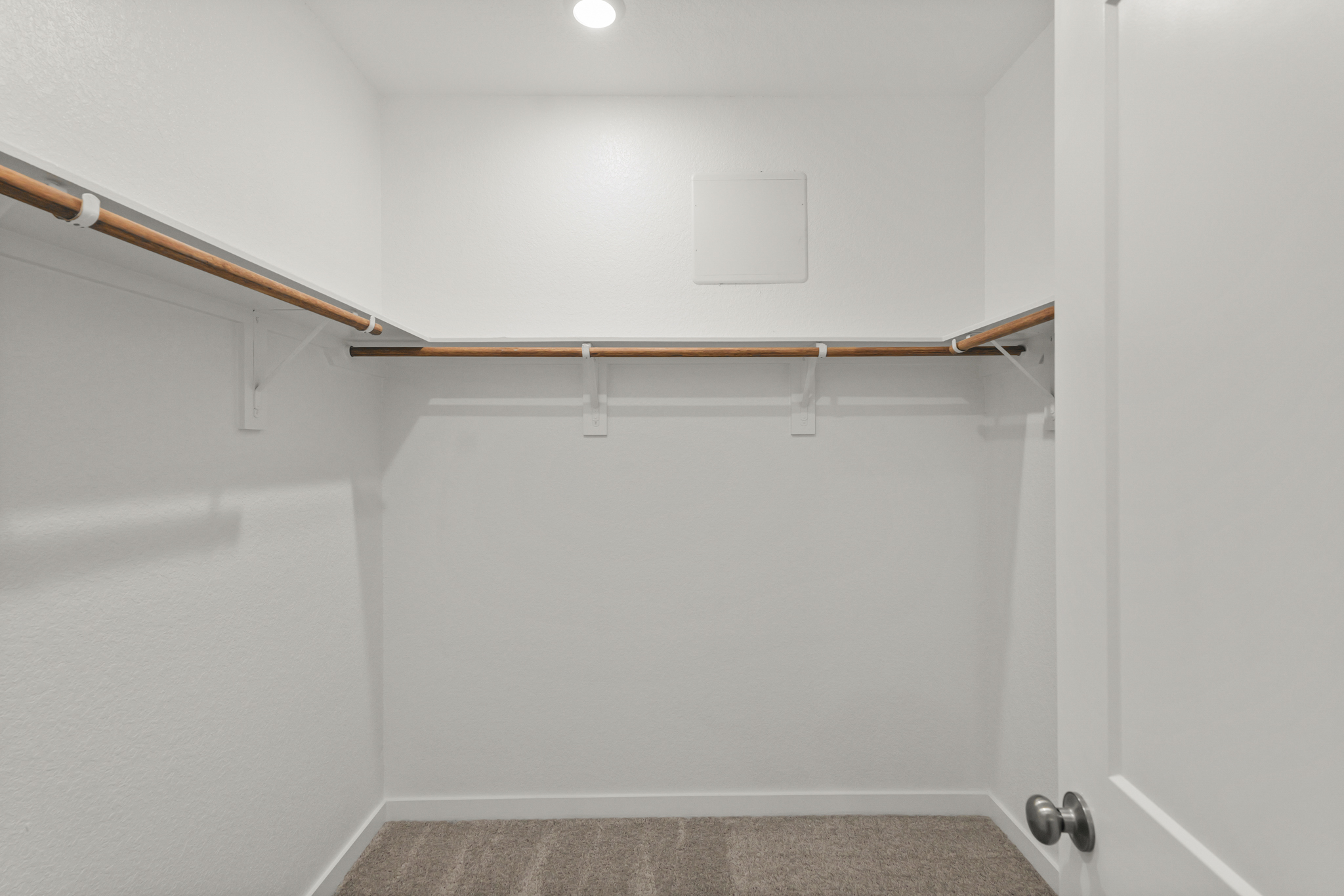 A white room with a metal bar.