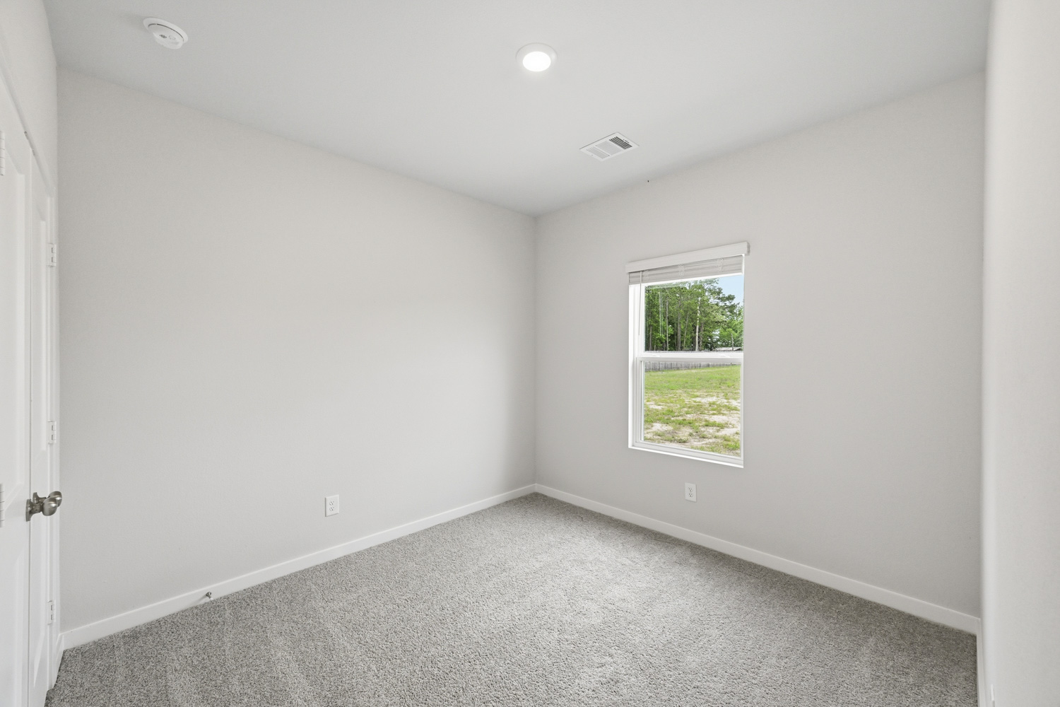 A room with a window and a door.